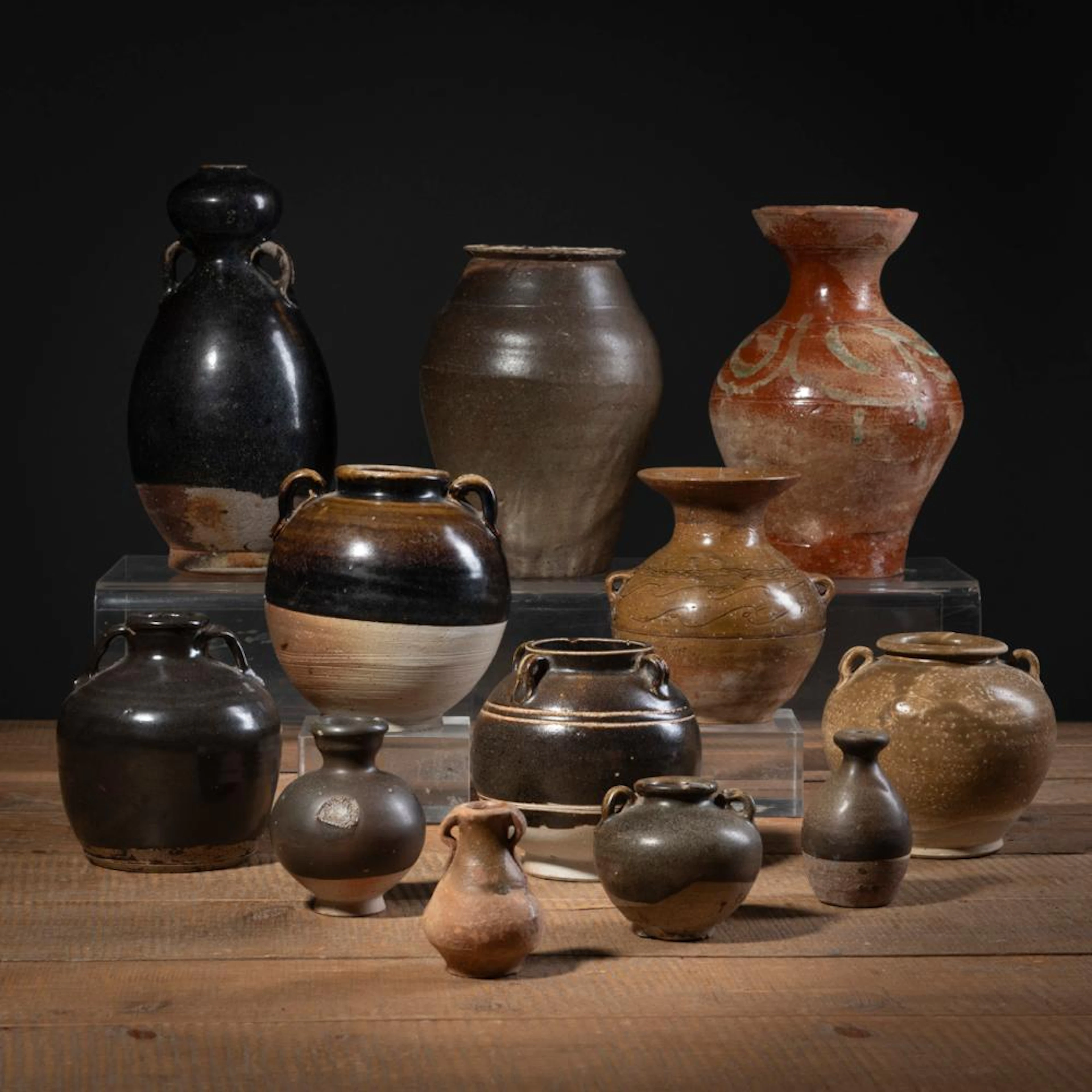 A GROUP OF THIRTEEN BROWN- AND BLACK-GLAZED VASES AND JARS