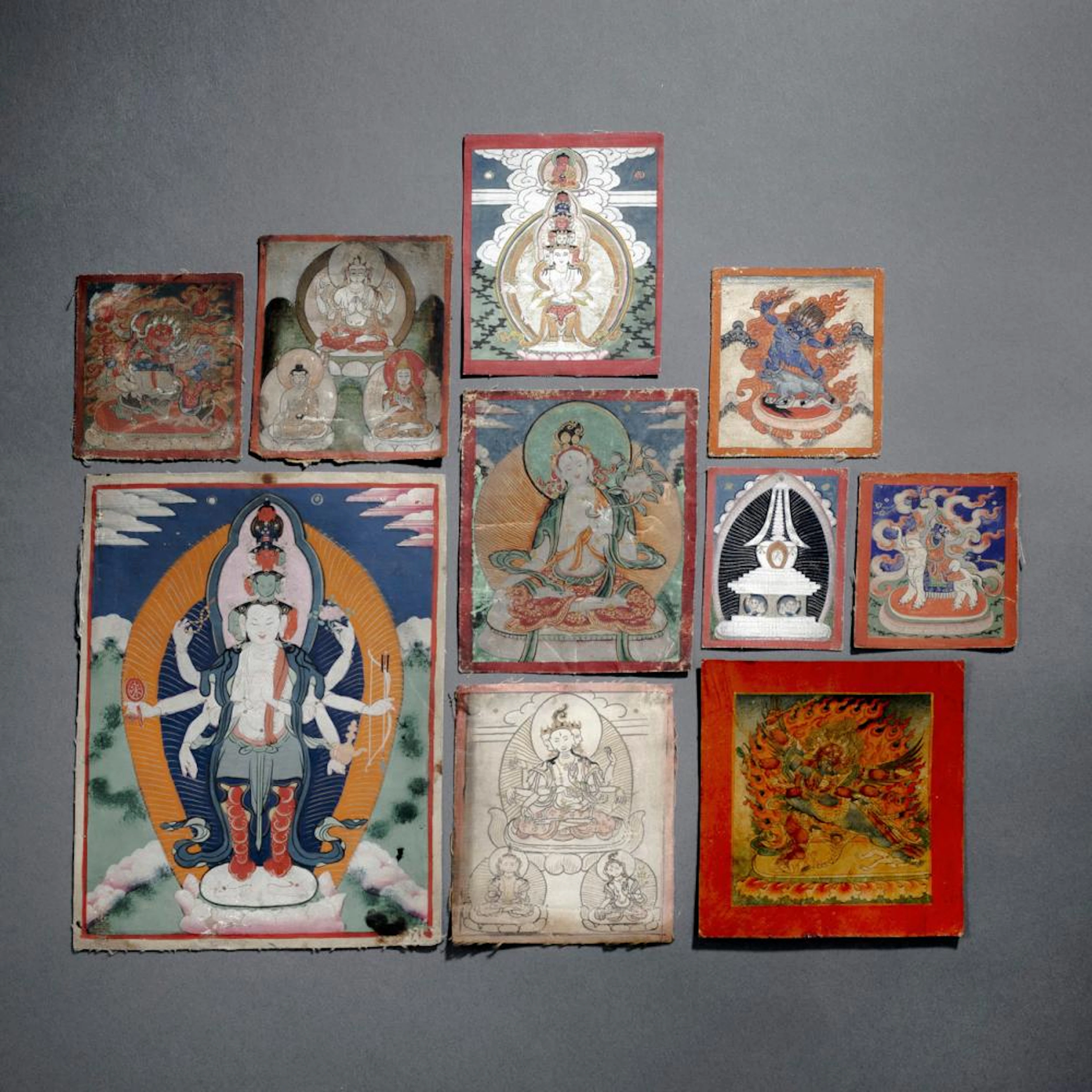 A GROUP OF TEN TSAGLI AND THANGKA