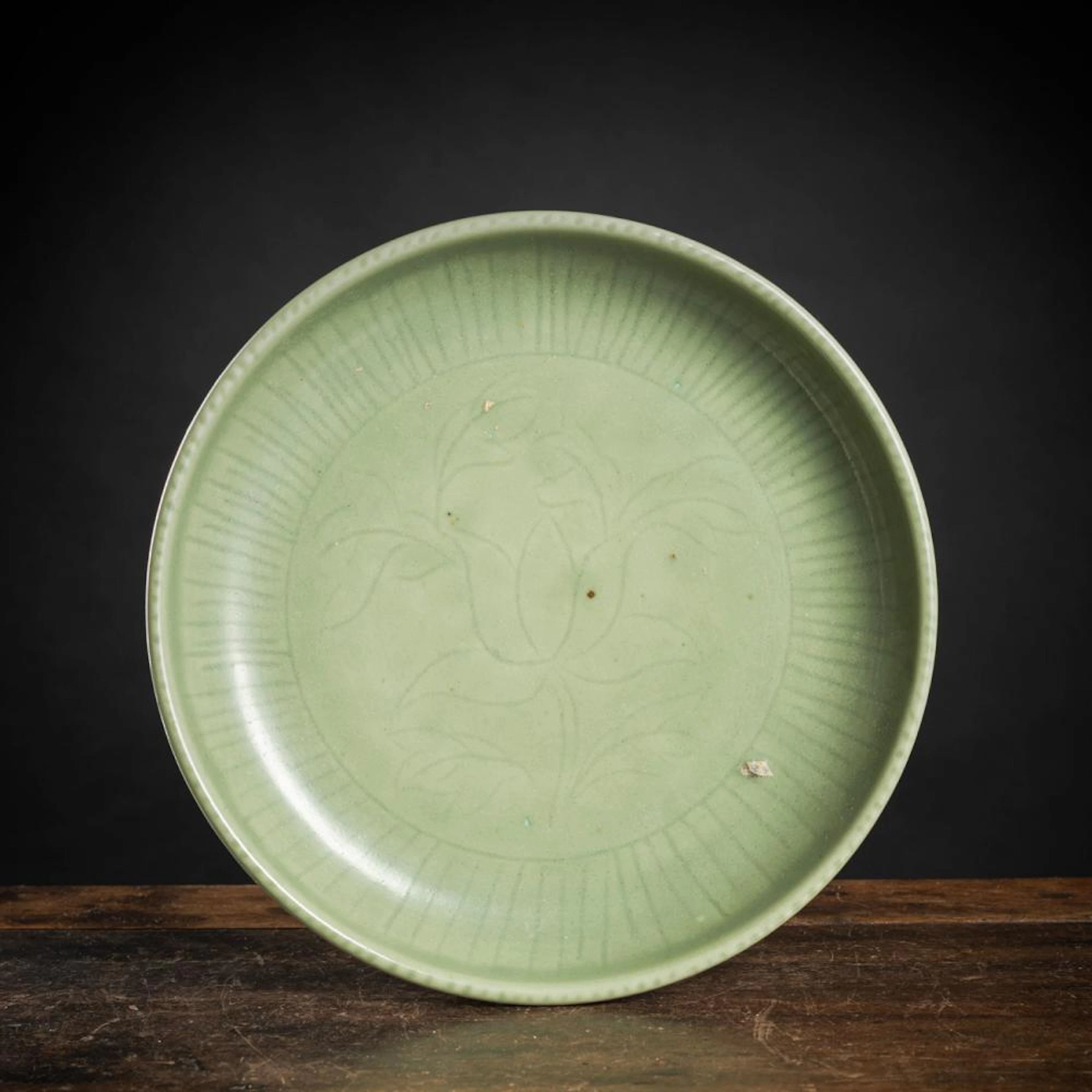 A CARVED LOTUS CELADON DISH