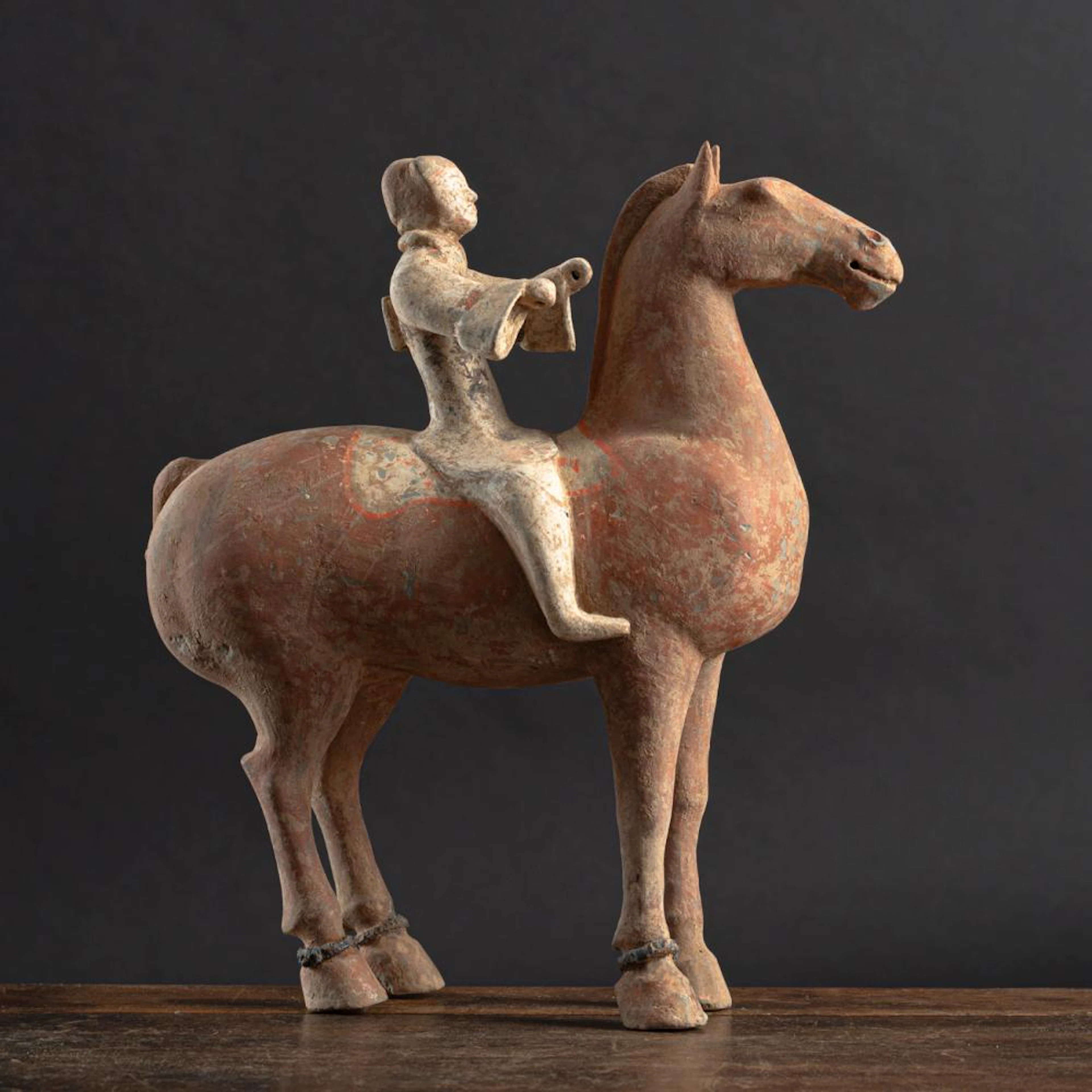 A POTTERY FIGURE OF A HORSE WITH RIDER