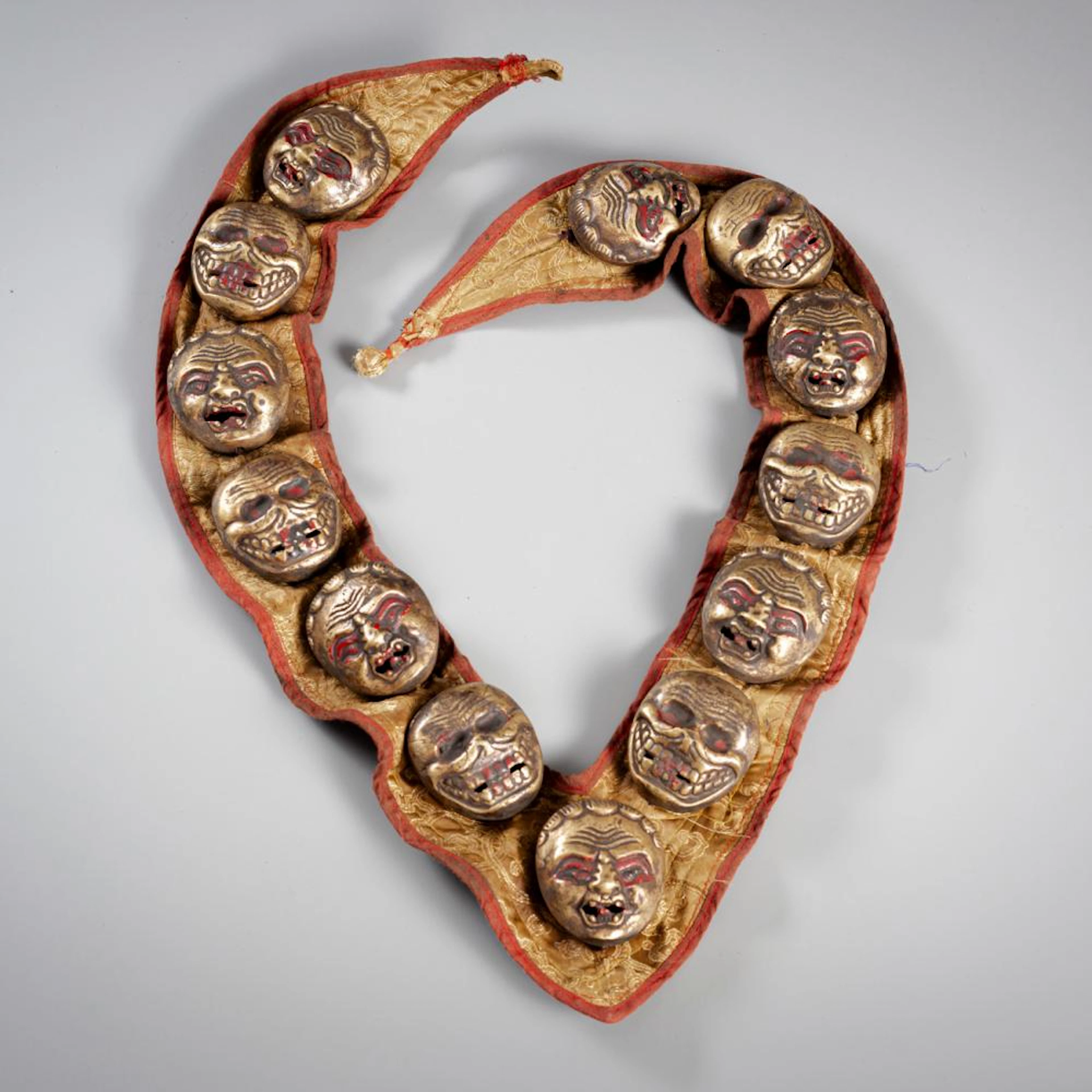 A RITUAL ORNAMENT WITH 13 BRONZE MASKS