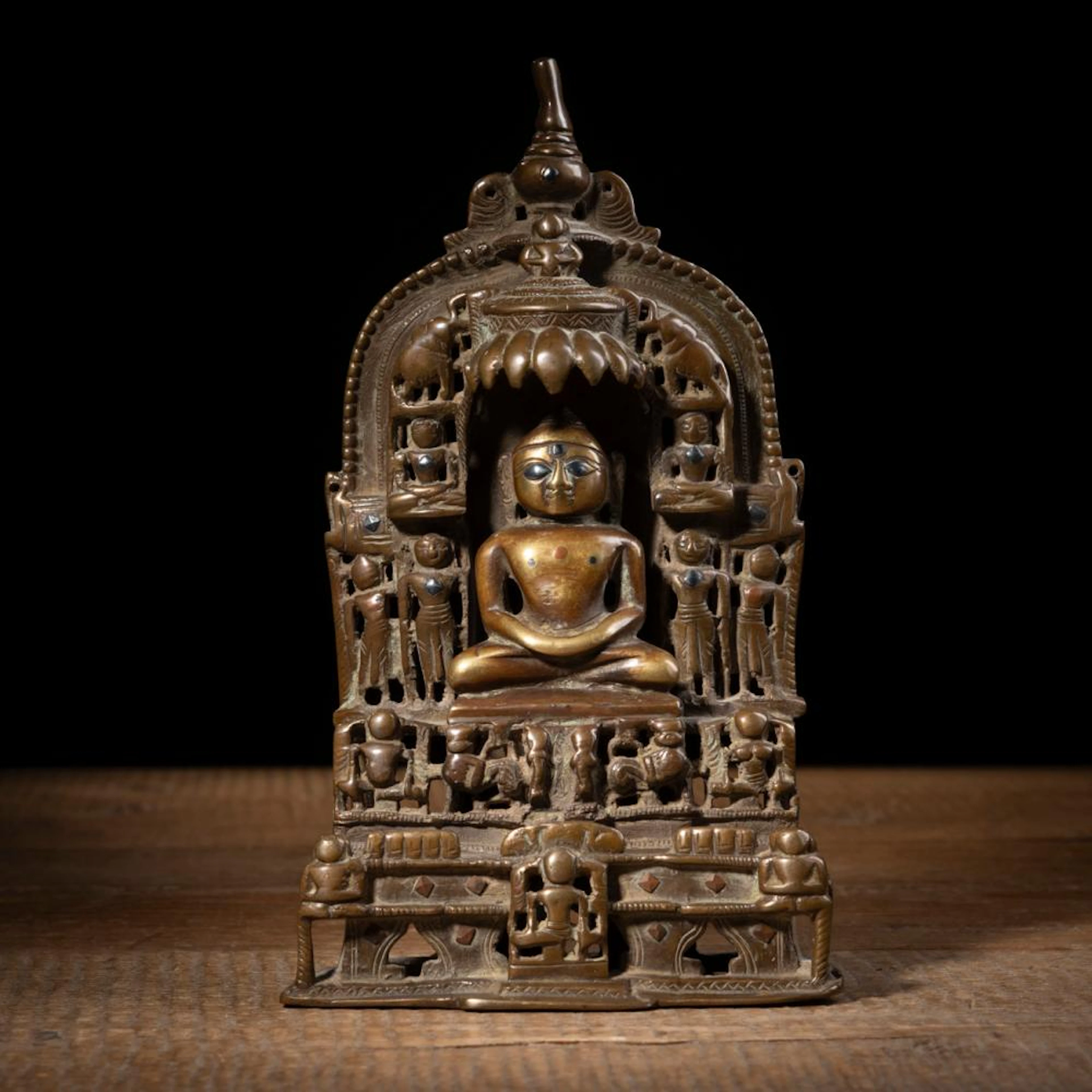AN INSCRIBED BRONZE FIGURE OF A JAIN TIRTHANKARA