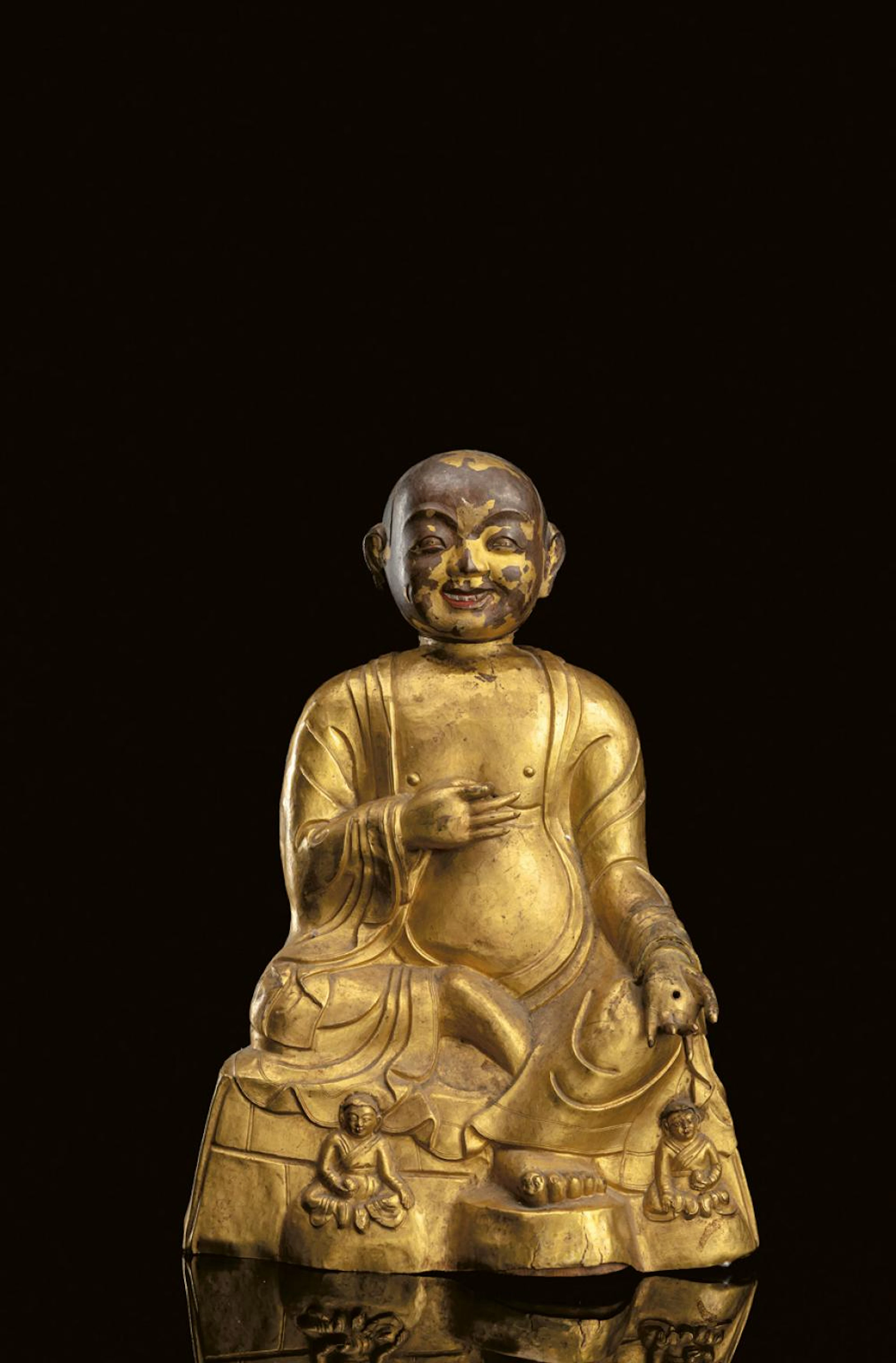 A GILT-EMBOSSED FIGURE OF AN ARHAT