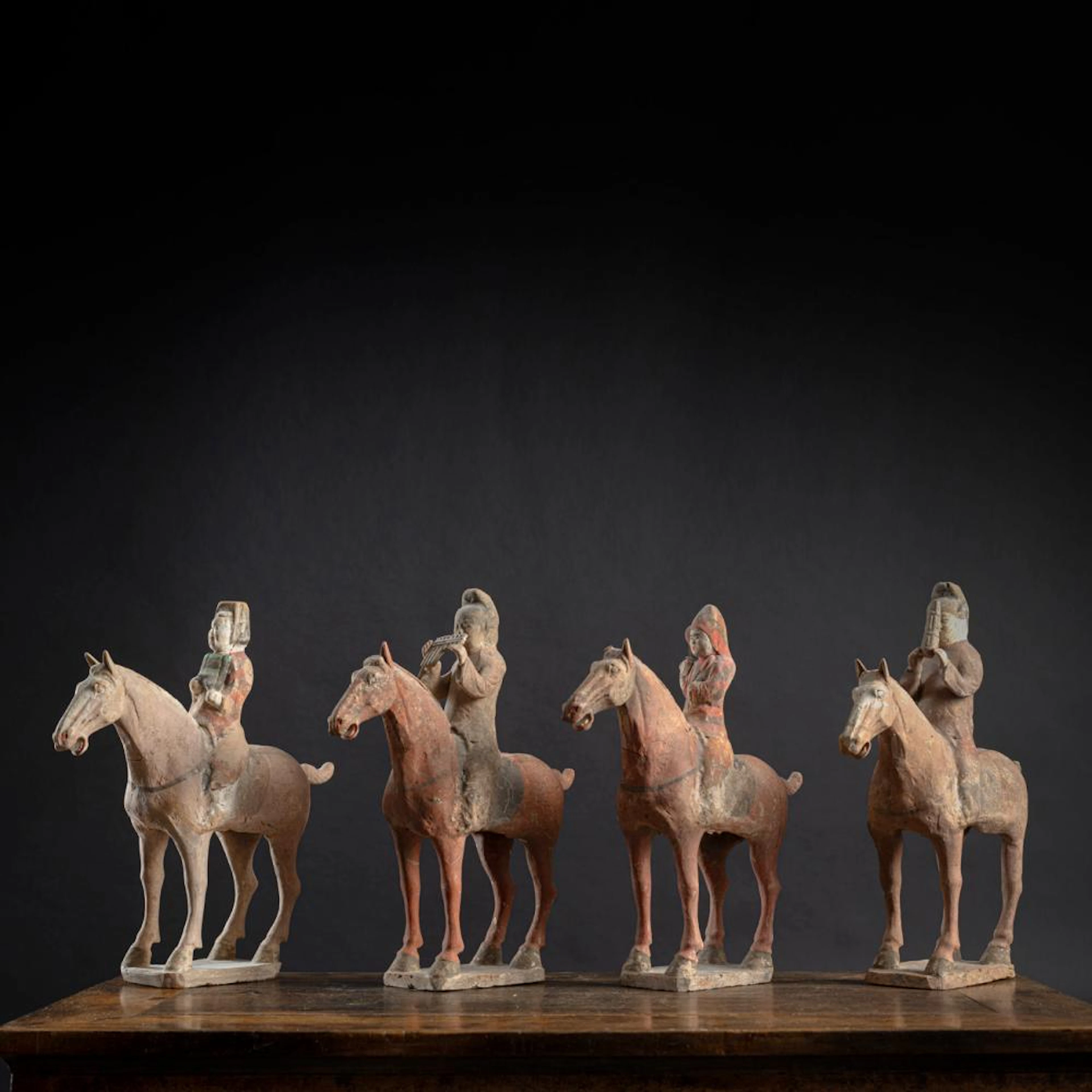 A GROUP OF FOUR POTTERY MODELS OF MOUNTED HORSES