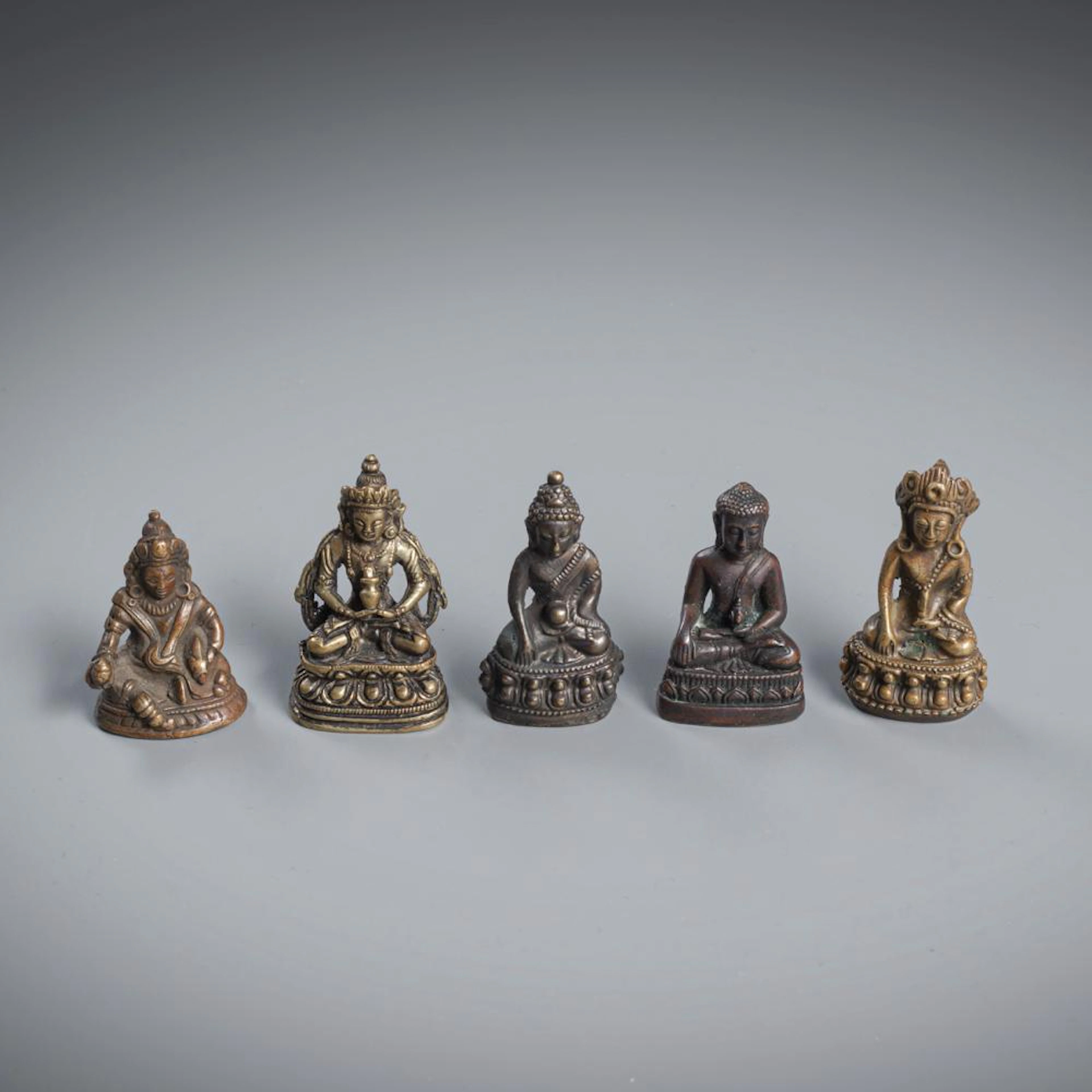 FIVE MINIATURE BRONZE FIGURES OF BUDDHA, AMITAYUS ET AL.