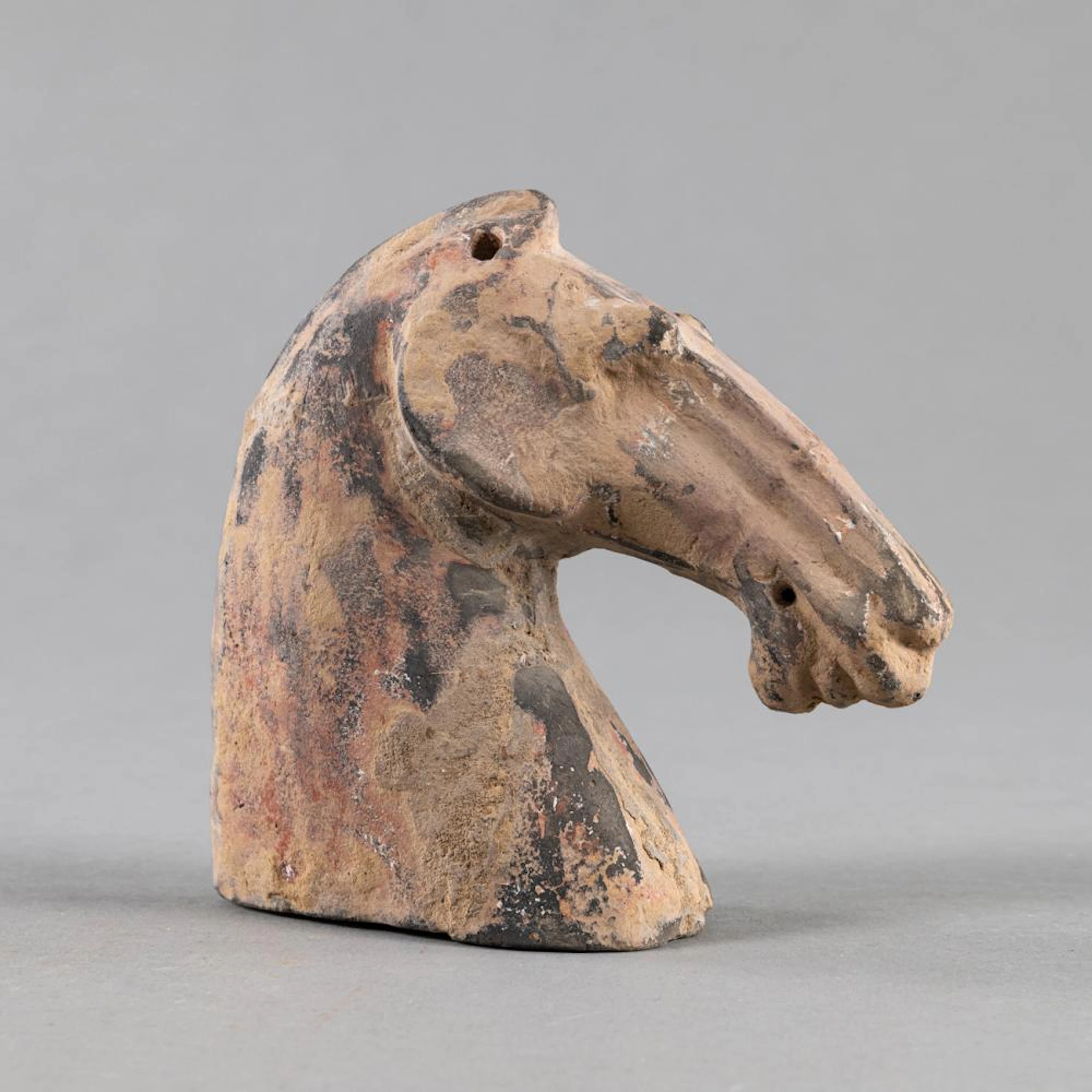 A POTTERY HORSE HEAD