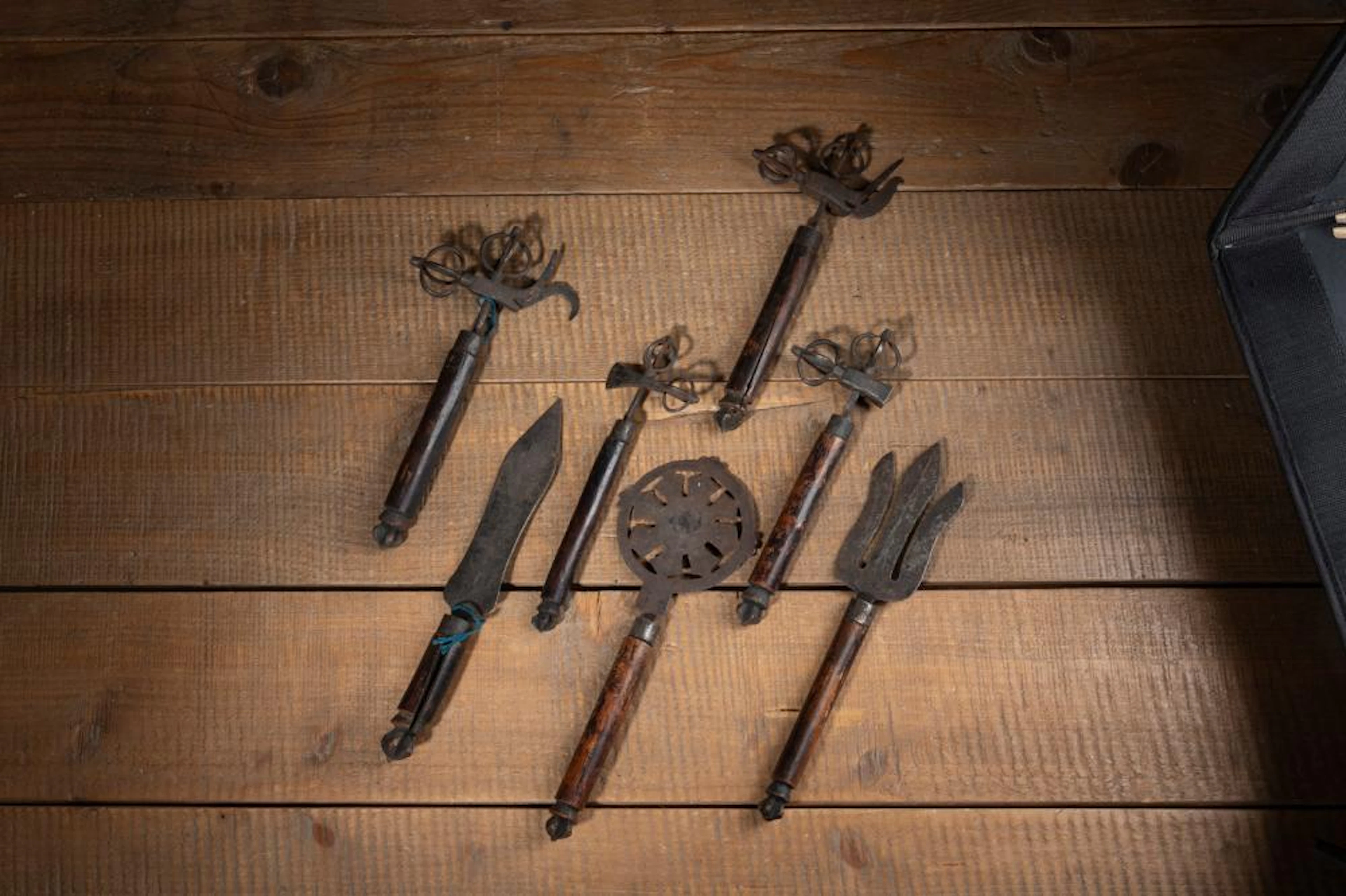 A GROUP OF IRON AND WOOD RITUAL UTENSILS