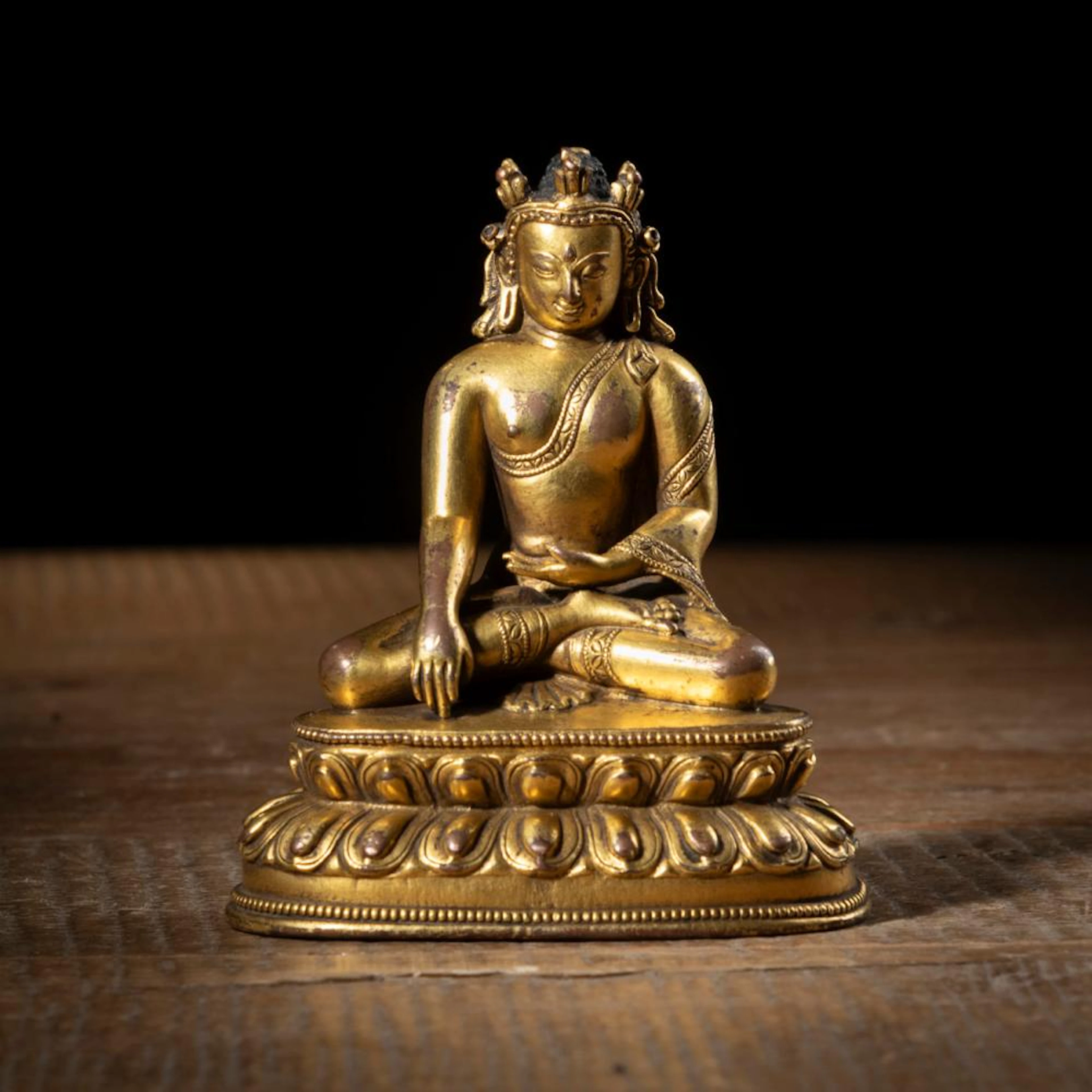 A GILT-BRONZE FIGURE OF THE CROWNED BUDDHA