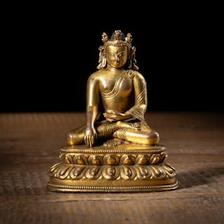 A GILT-BRONZE FIGURE OF THE CROWNED BUDDHA