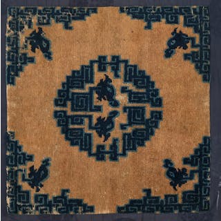 A SITTING RUG WITH STYLIZED DRAGONS