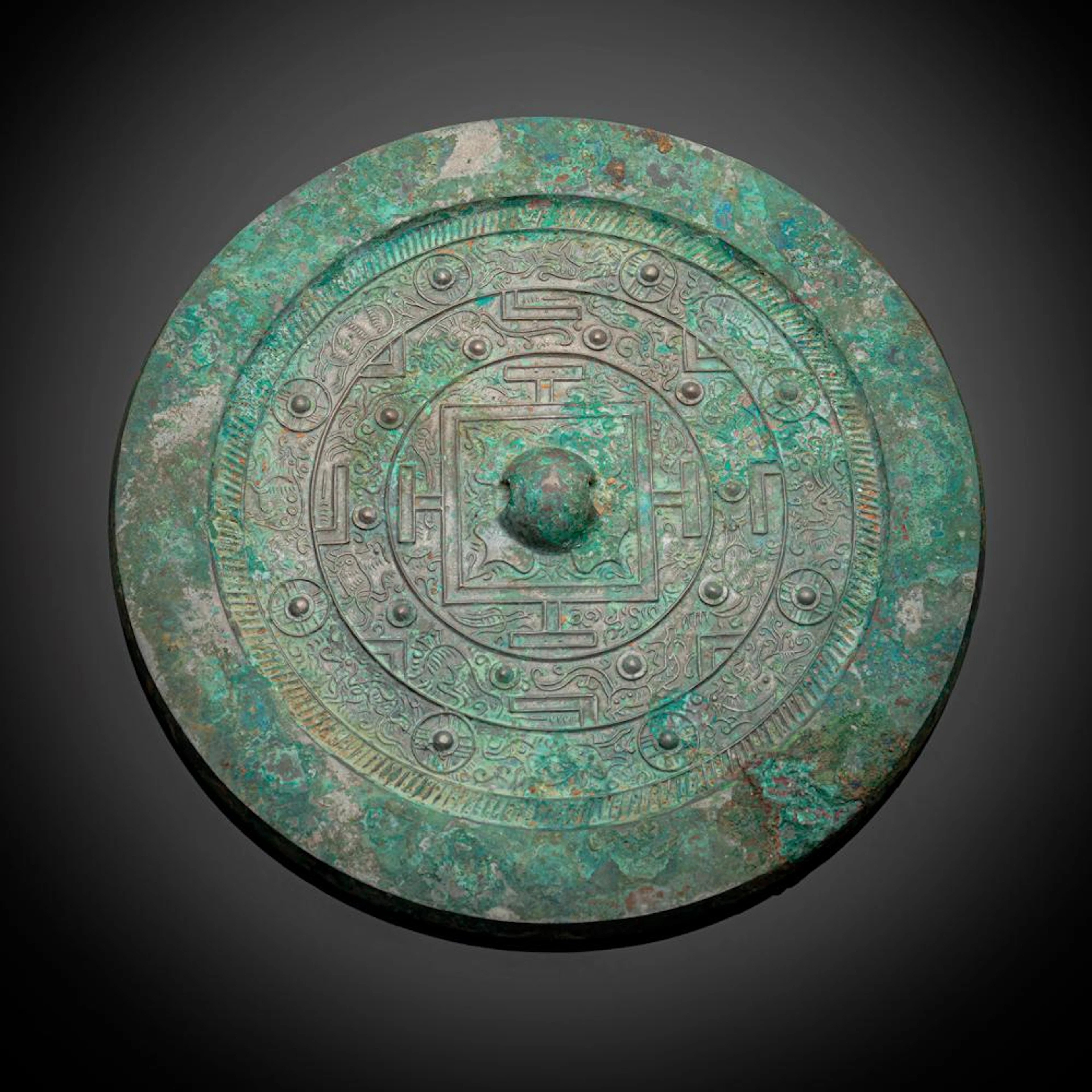 A TLV BRONZE MIRROR PARTLY GREEN CORRODED