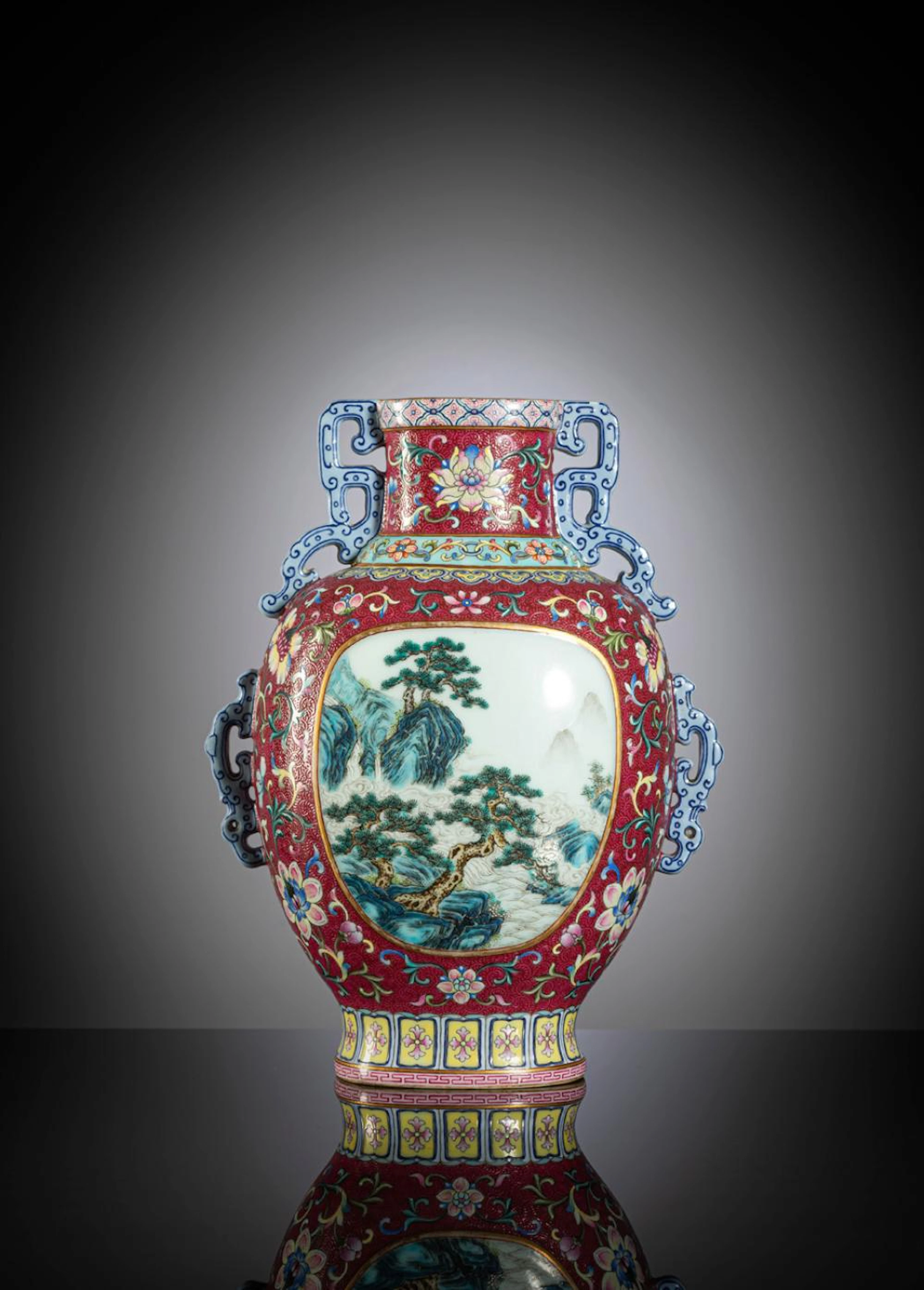 A SUPERB YANGCAI RUBY-RED GROUND VASE WITH LOTUS AND TOW LANDSCAPE PANELS