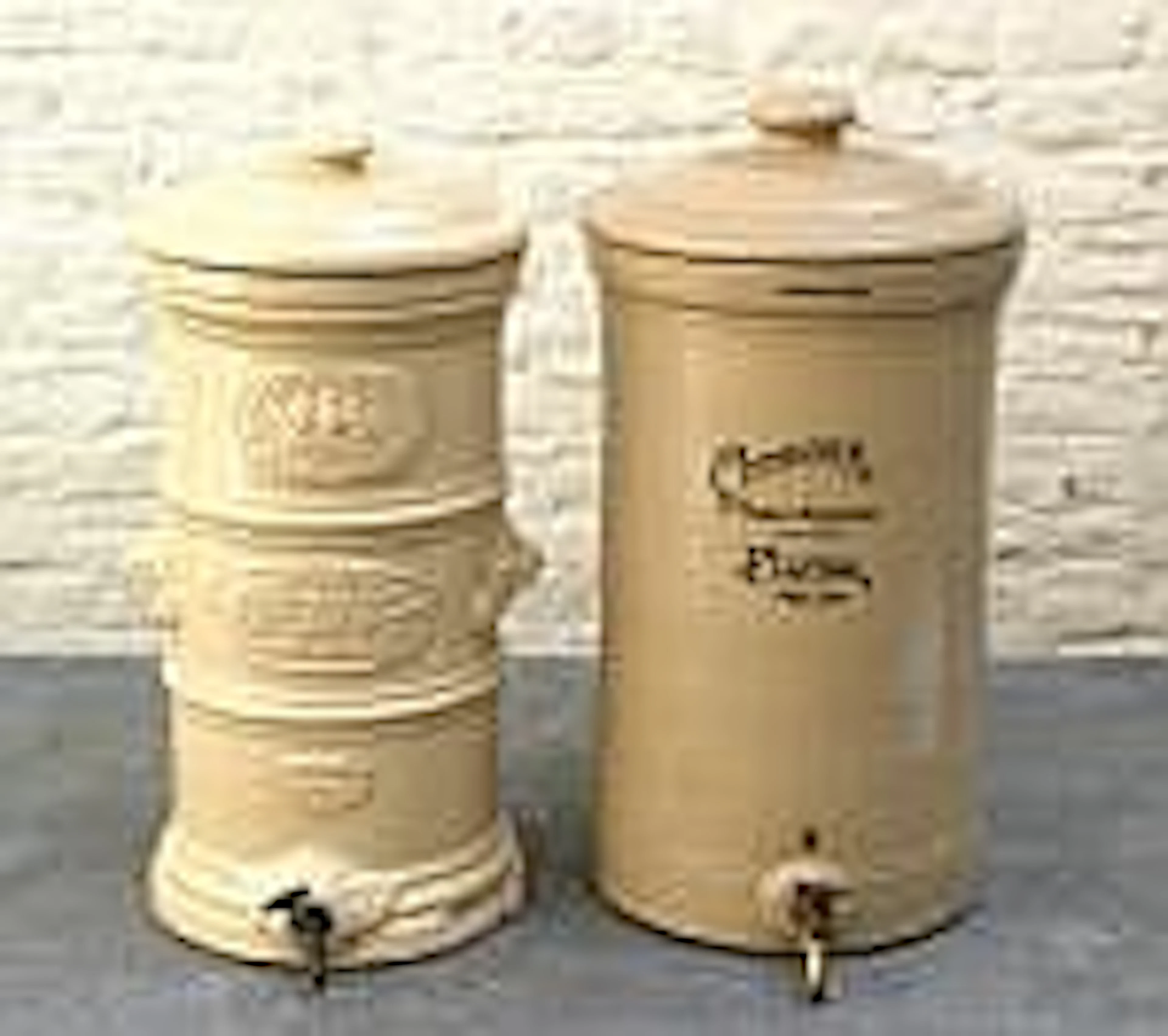 Two glazed earthenware water purifiers, damaged,