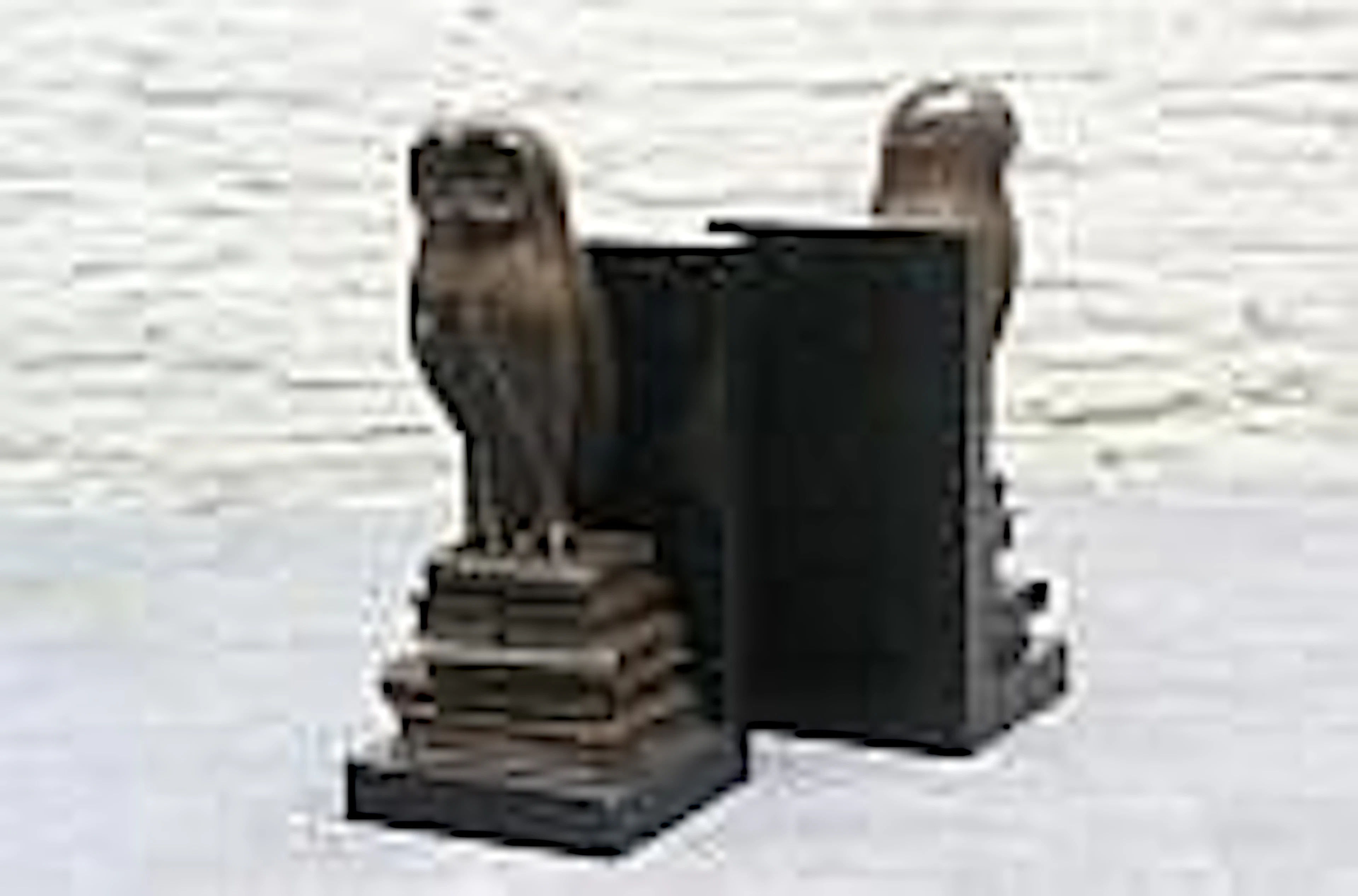 Bronze book supports on stone base, Owl on books,