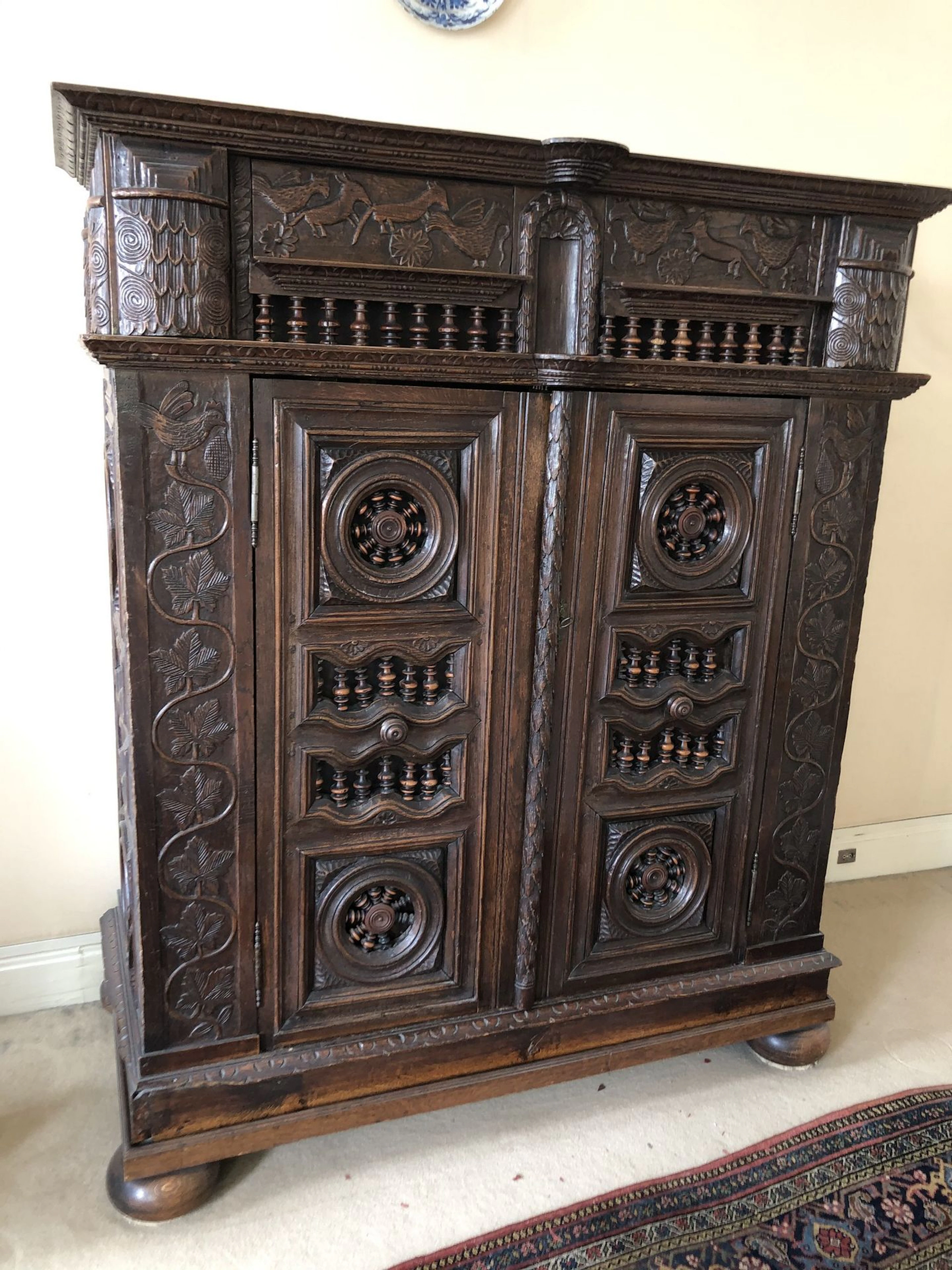 Armoire en bois naturel mouluré et sculpté..