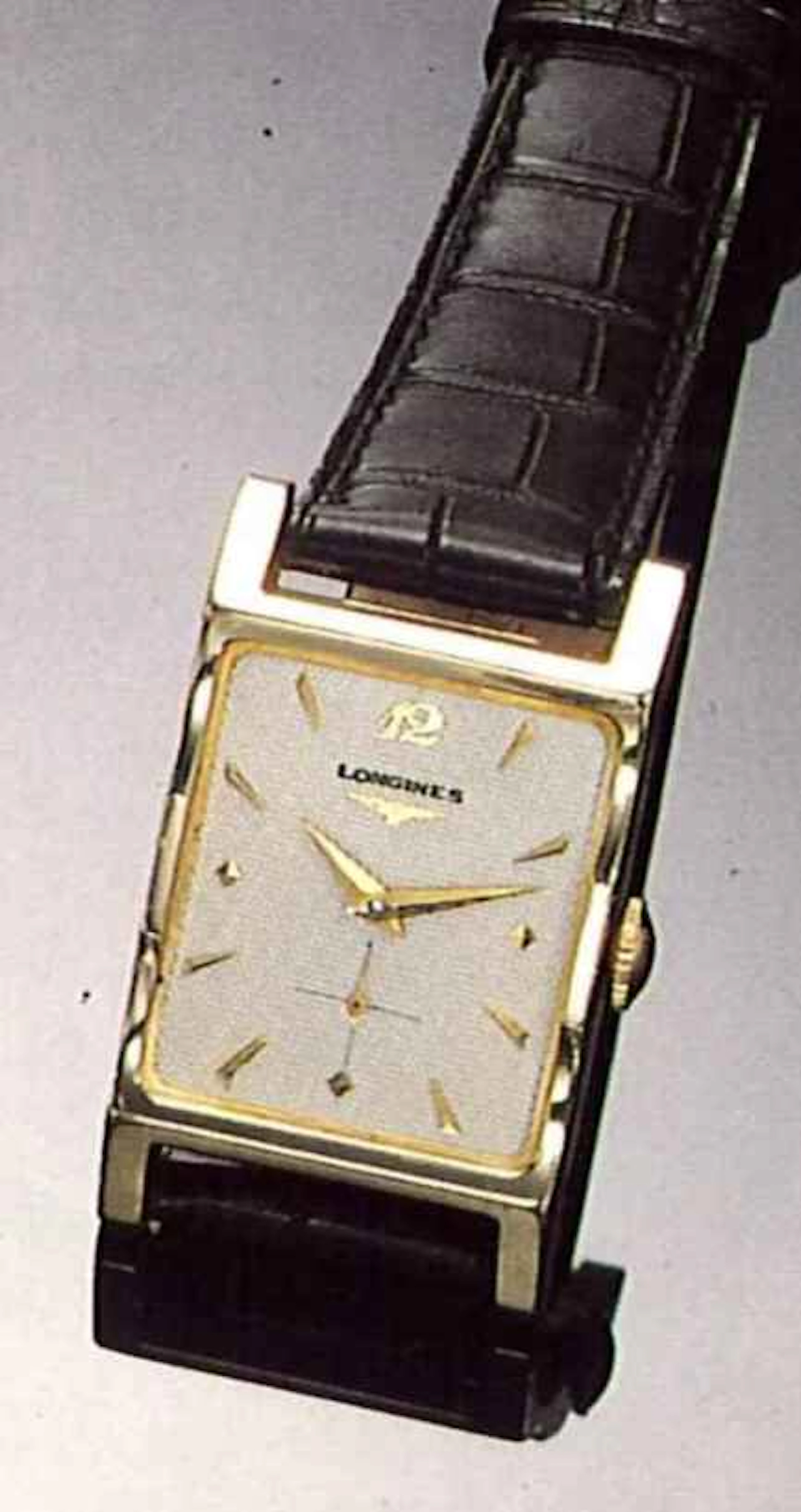 Longines, per il mercato Nord Americano, anni '50. Interessante orologio da polso, per uomo, rettangolare, in oro 14 ct.