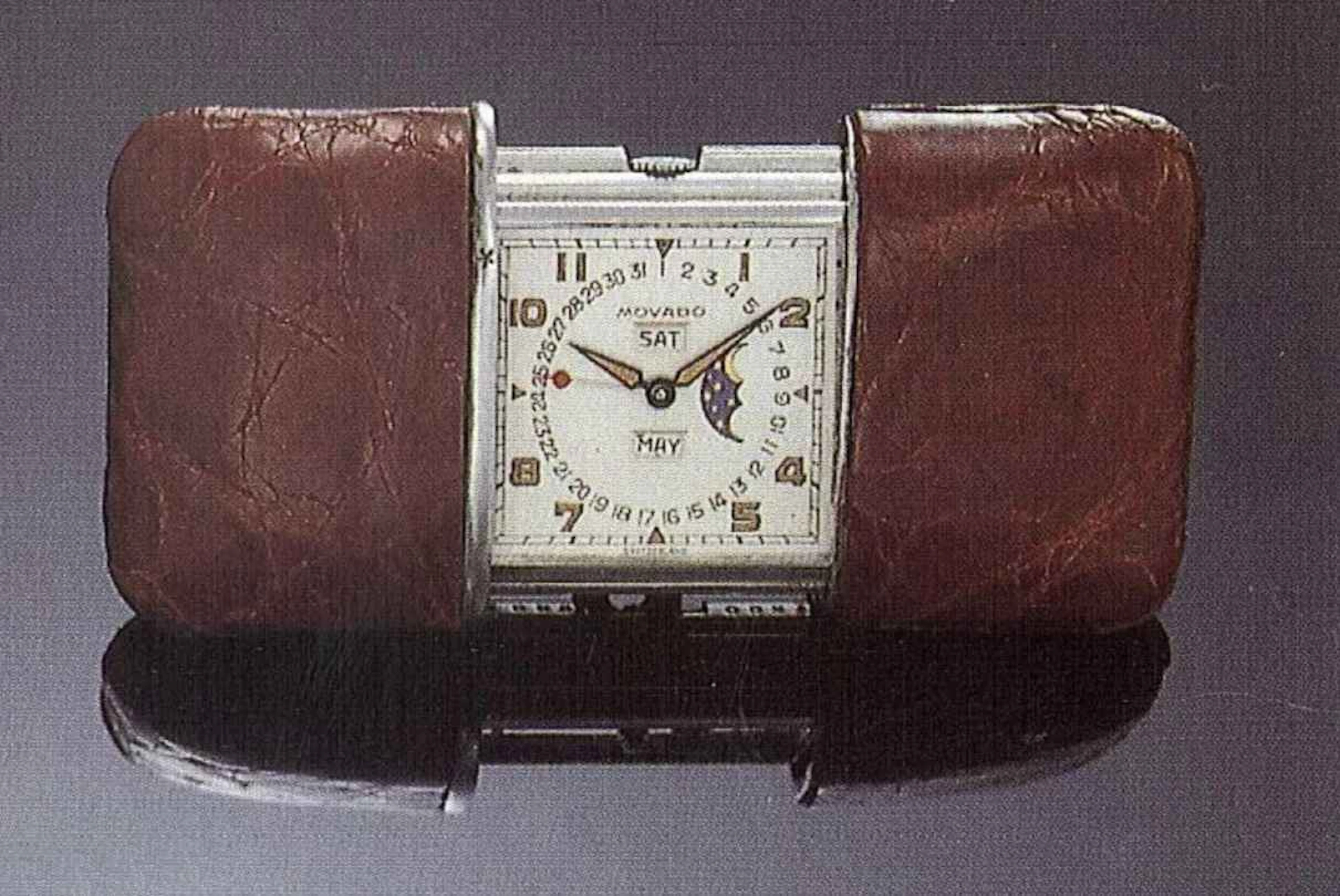 Movado "Ermeto", Switzerland, anni '40. Interessante orologio da borsetta, in acciaio, ricoperto in pelle, astronomico, tripla data, fasi di luna, carica automatica.