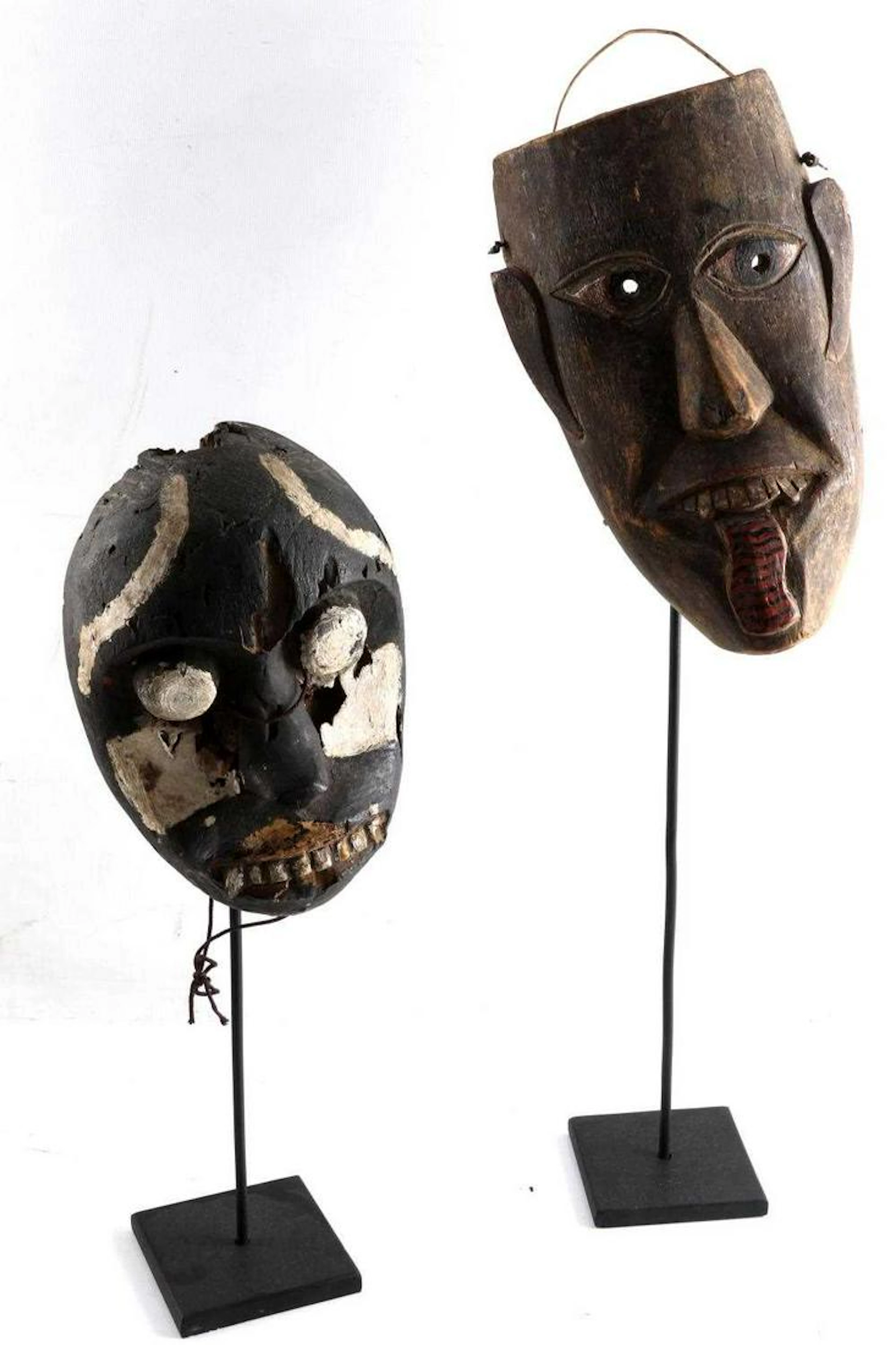 Lot of two painted wooden masks on metal stands