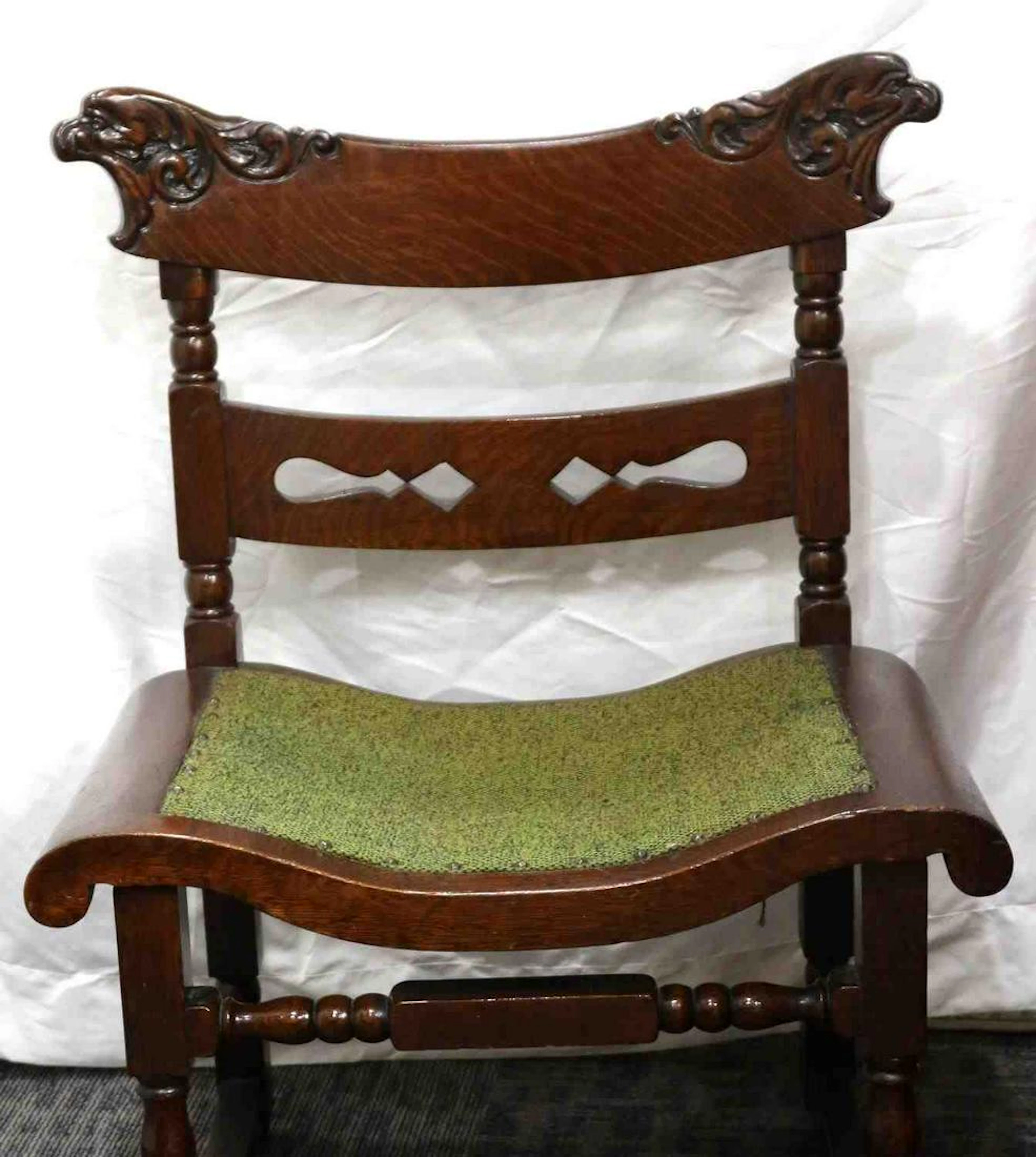 Small ornate carved dark wood chair w green cloth
