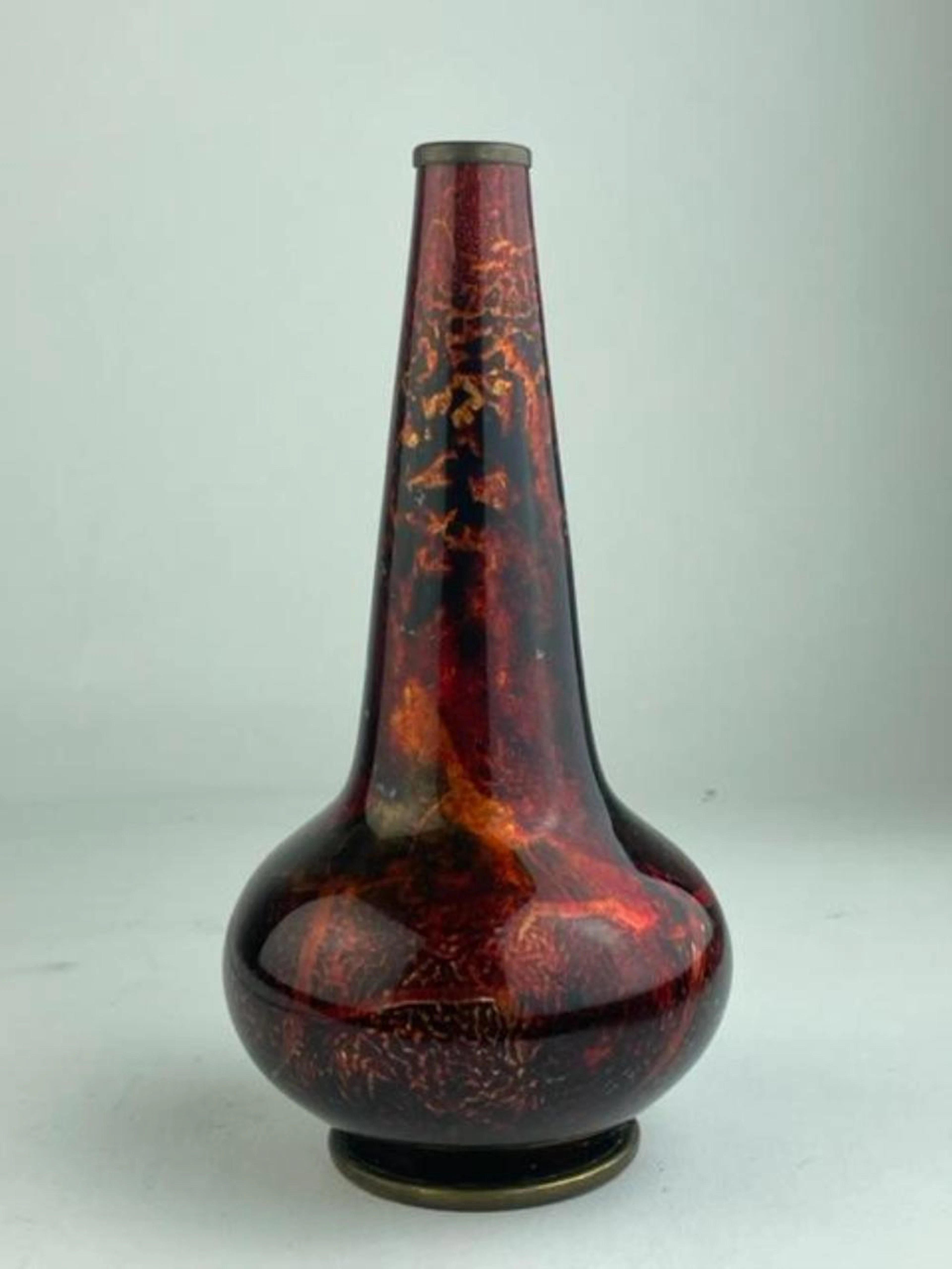French enamel vase in red and deeper red streaks in a boulbous form leading to a
