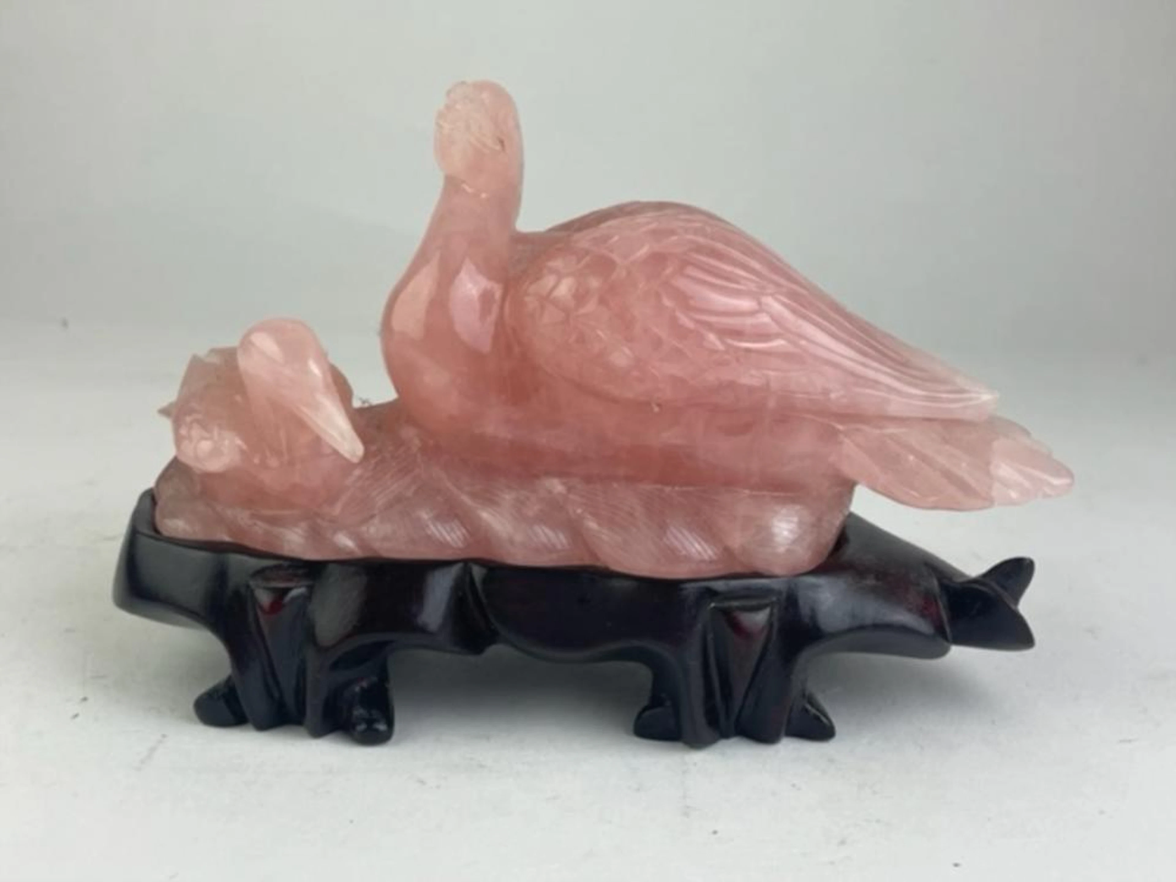 Rose quartz figurine of 2 ducks on a wood base