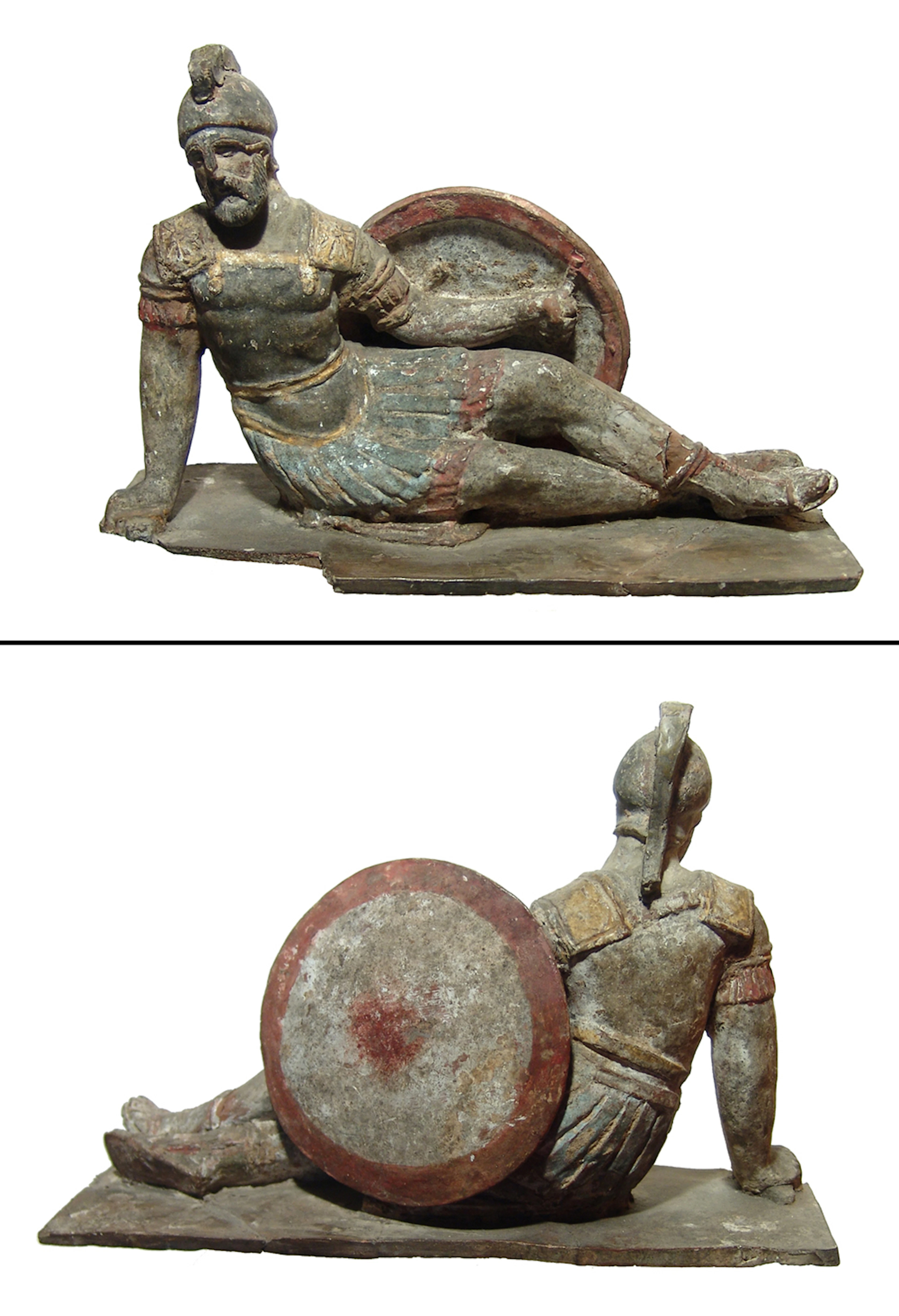 An antique polychrome terracotta figure of a reclining hoplite