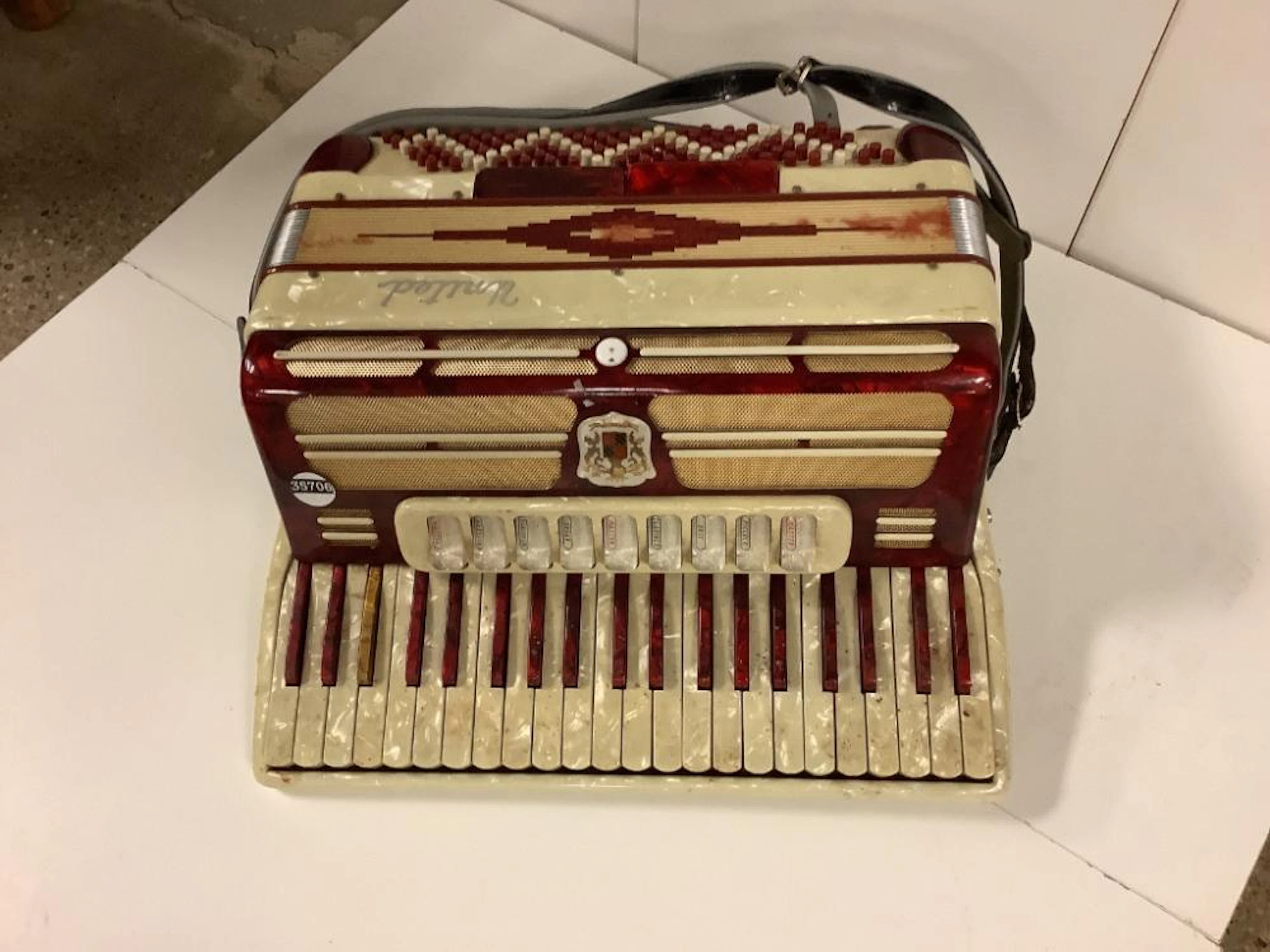 Antique accordion, red and ivory