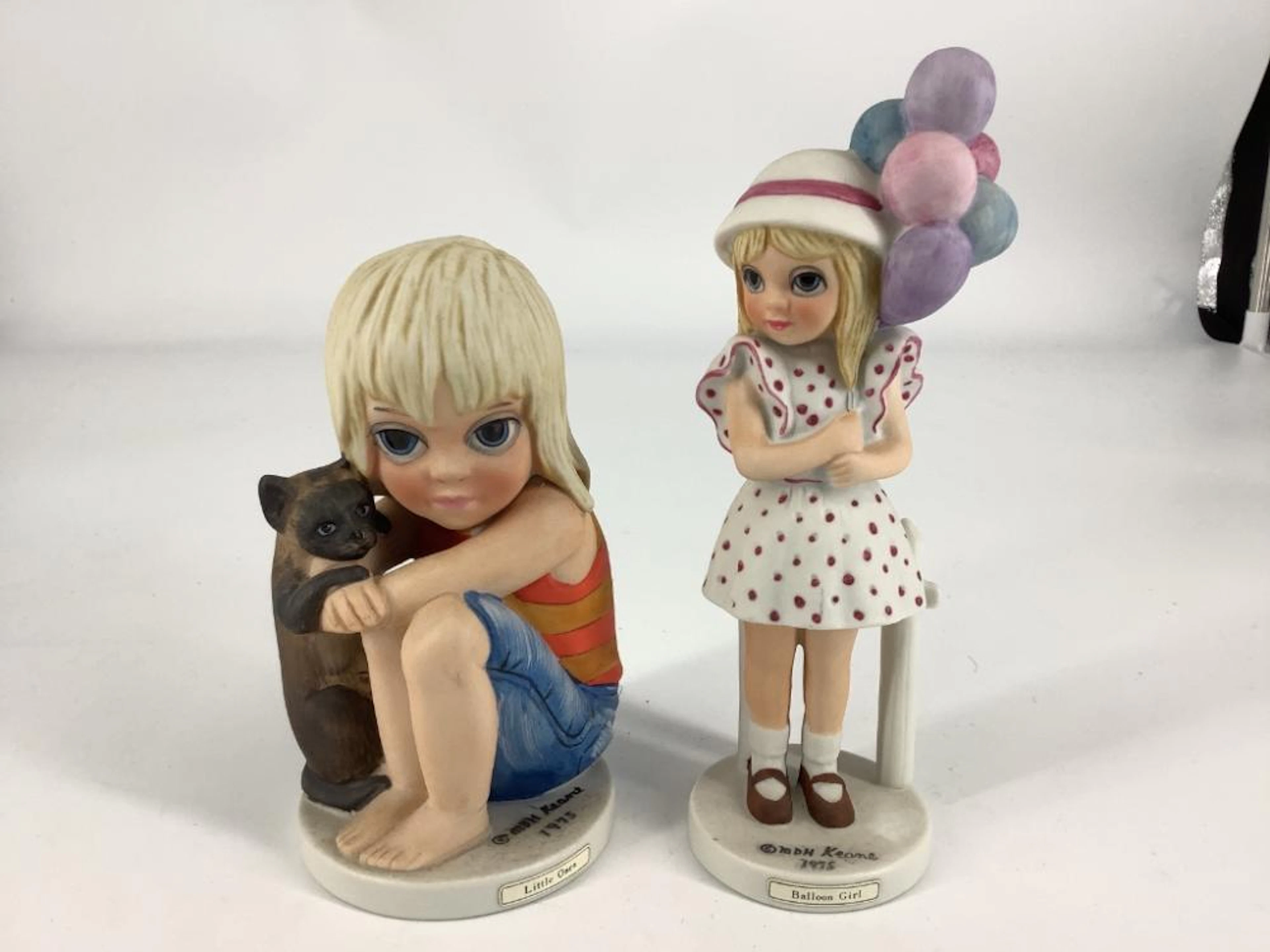 2 Margaret Keane figurines including little ones. Ranging from 6.5?-5.5?.