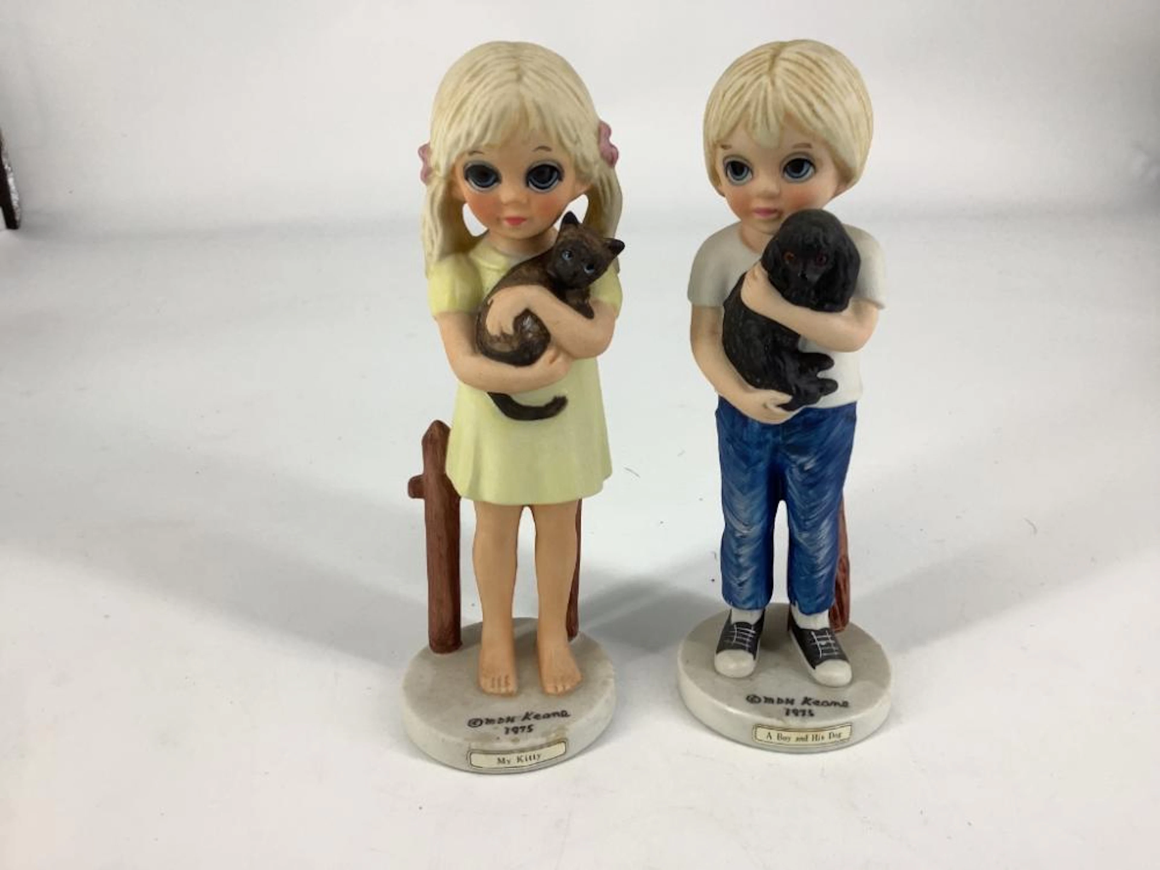 2 Margaret Keane figurines including a boy & his dog. Both 6.5?