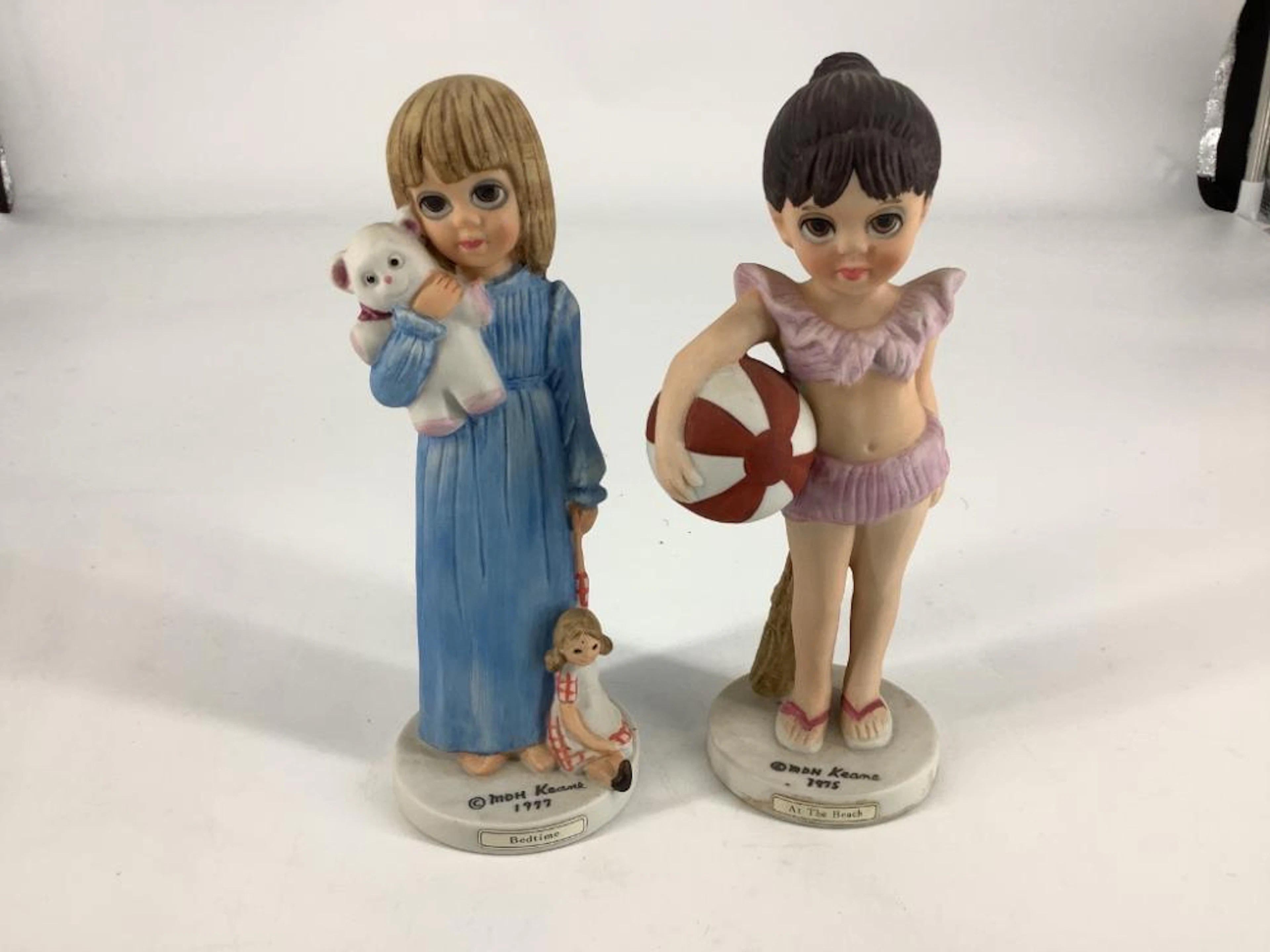 2 Margaret Keane figurines including at the beach. Both 6.5?