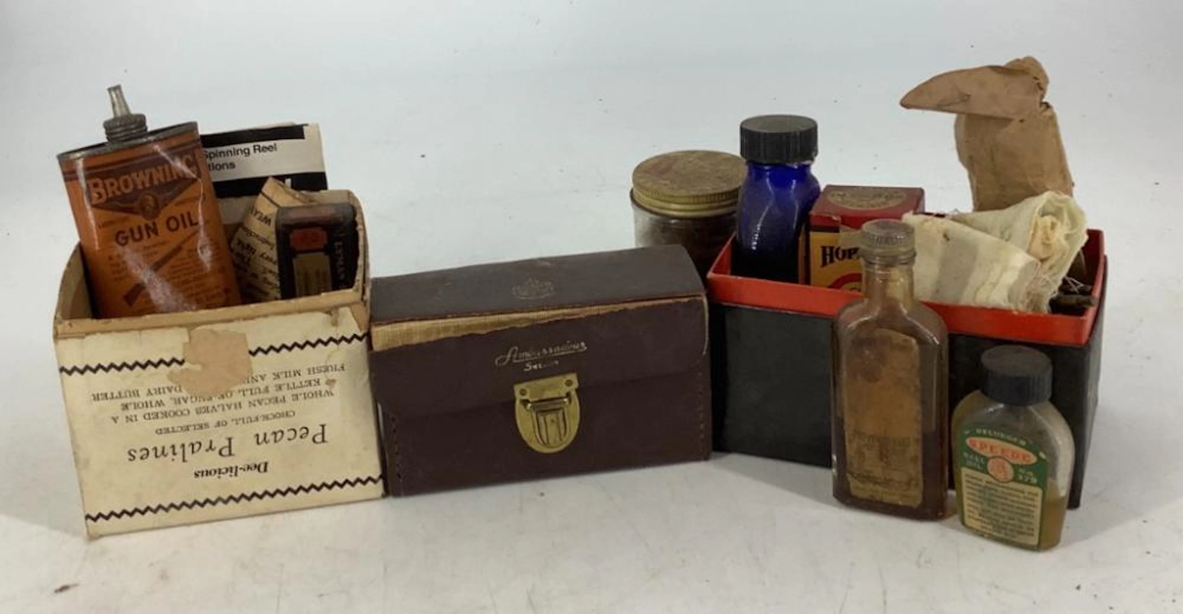 Lot of old bottles of gun oil, gun cleaning patches, old fly line cleaner etc.