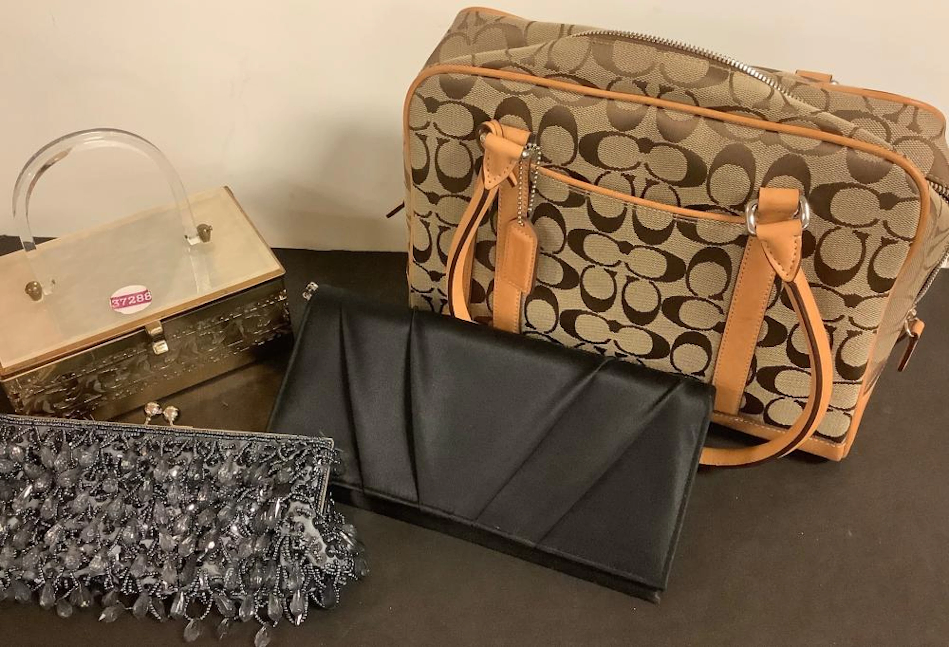 Lot of 4 handbags including a Coach purse that appears to have never been used