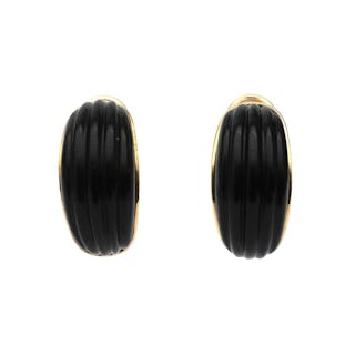 A pear of 14 karat gold earrings with onyx