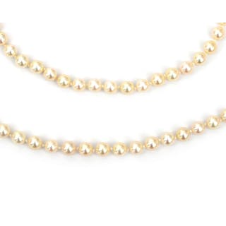 Two pearl necklaces to a 14 karat gold clasp with diamonds