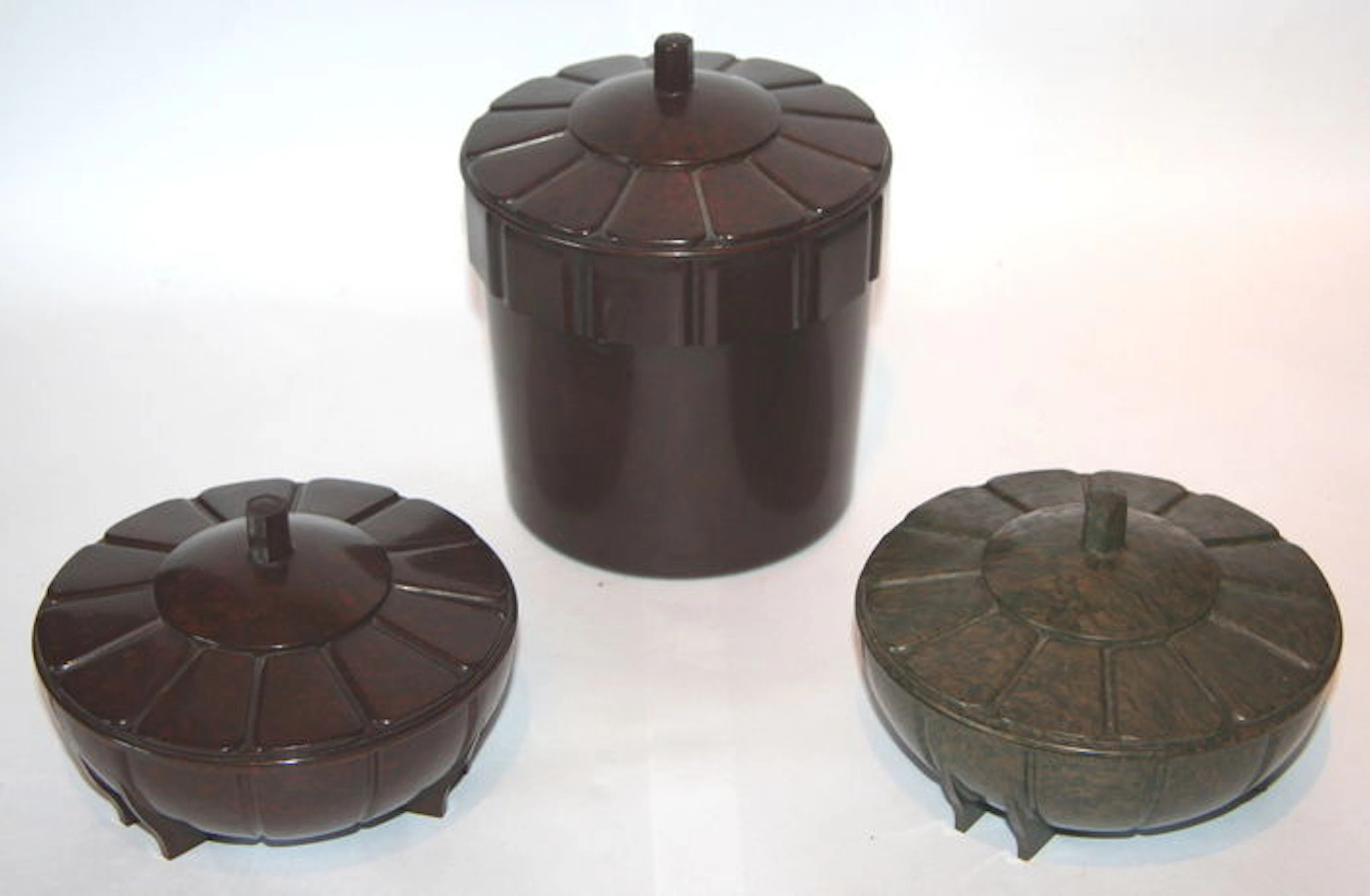 Three round art deco geometric bakelite storage boxes