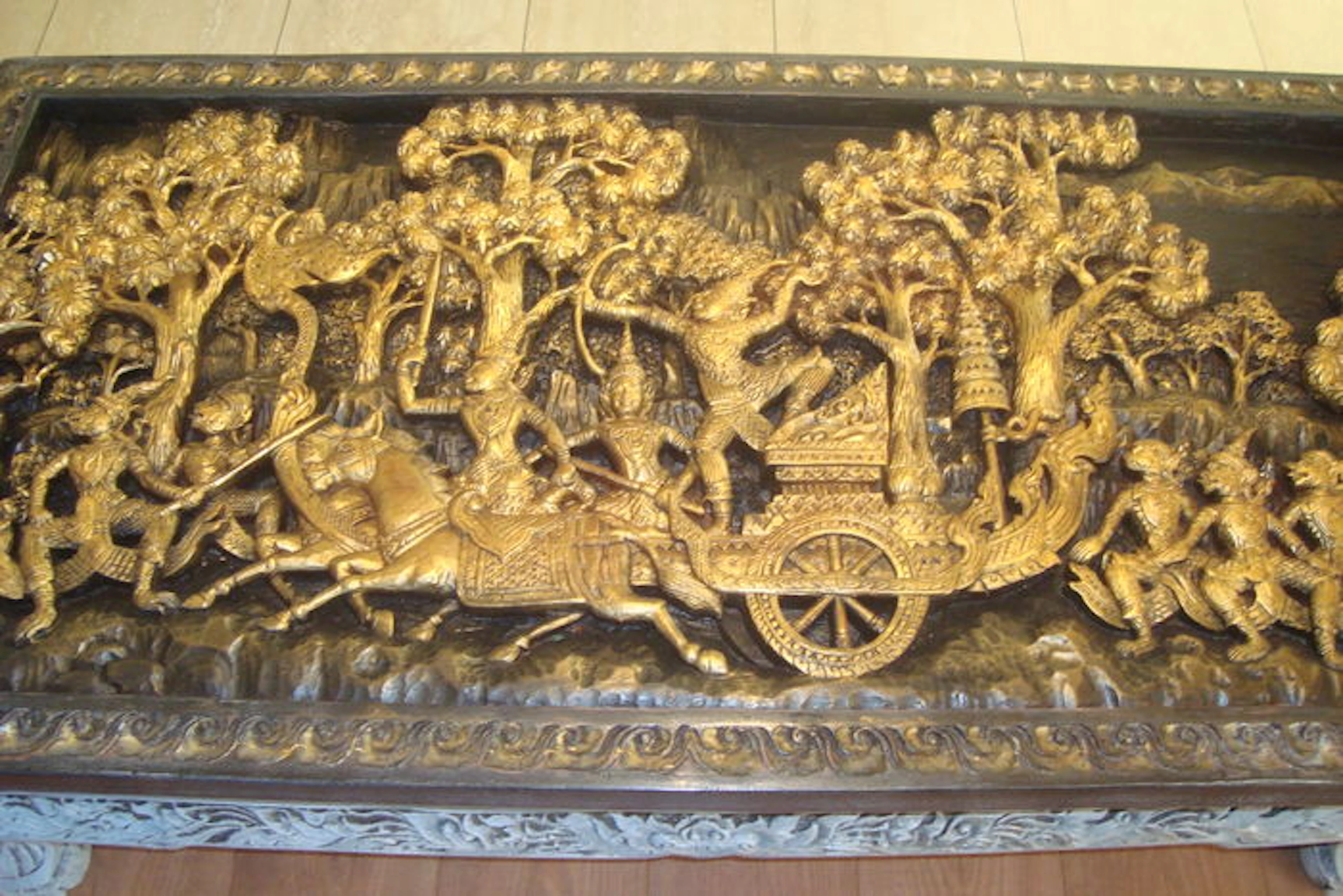 A wood coffee table with gilt design - Thailand - second half of 20th century