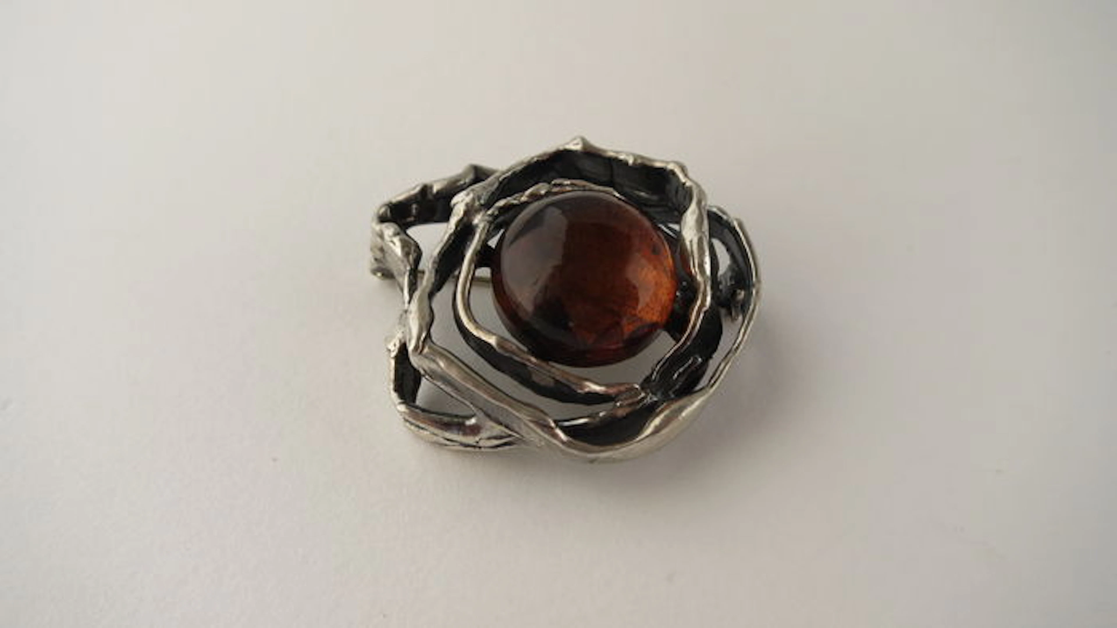 Silver vintage brooch with round amber.