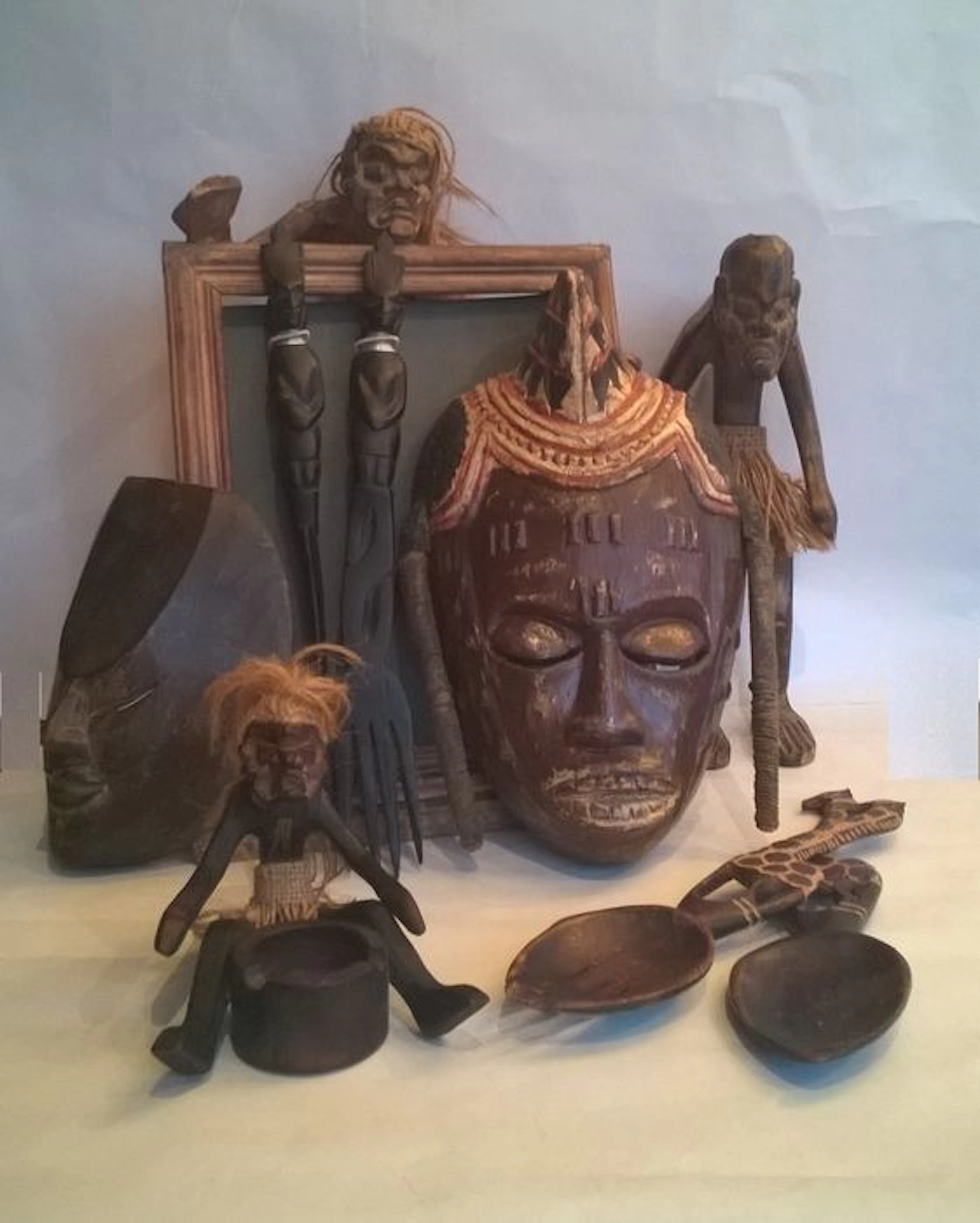 A collection of 9 Tribal items; masks, sculptures and everyday items.