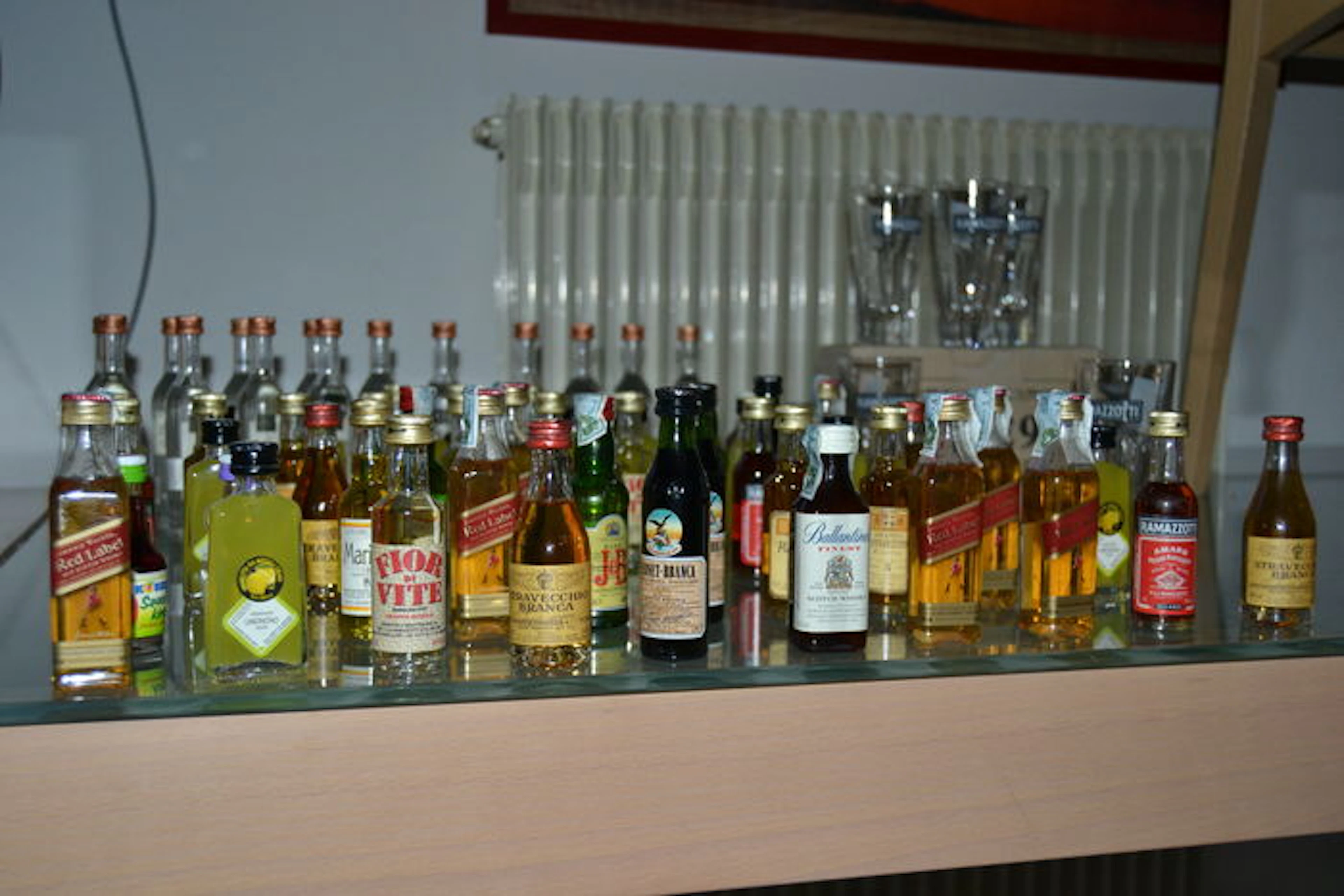 80 sealed miniature bottles and 6 glasses of Amaro Ramazzotti limited edition