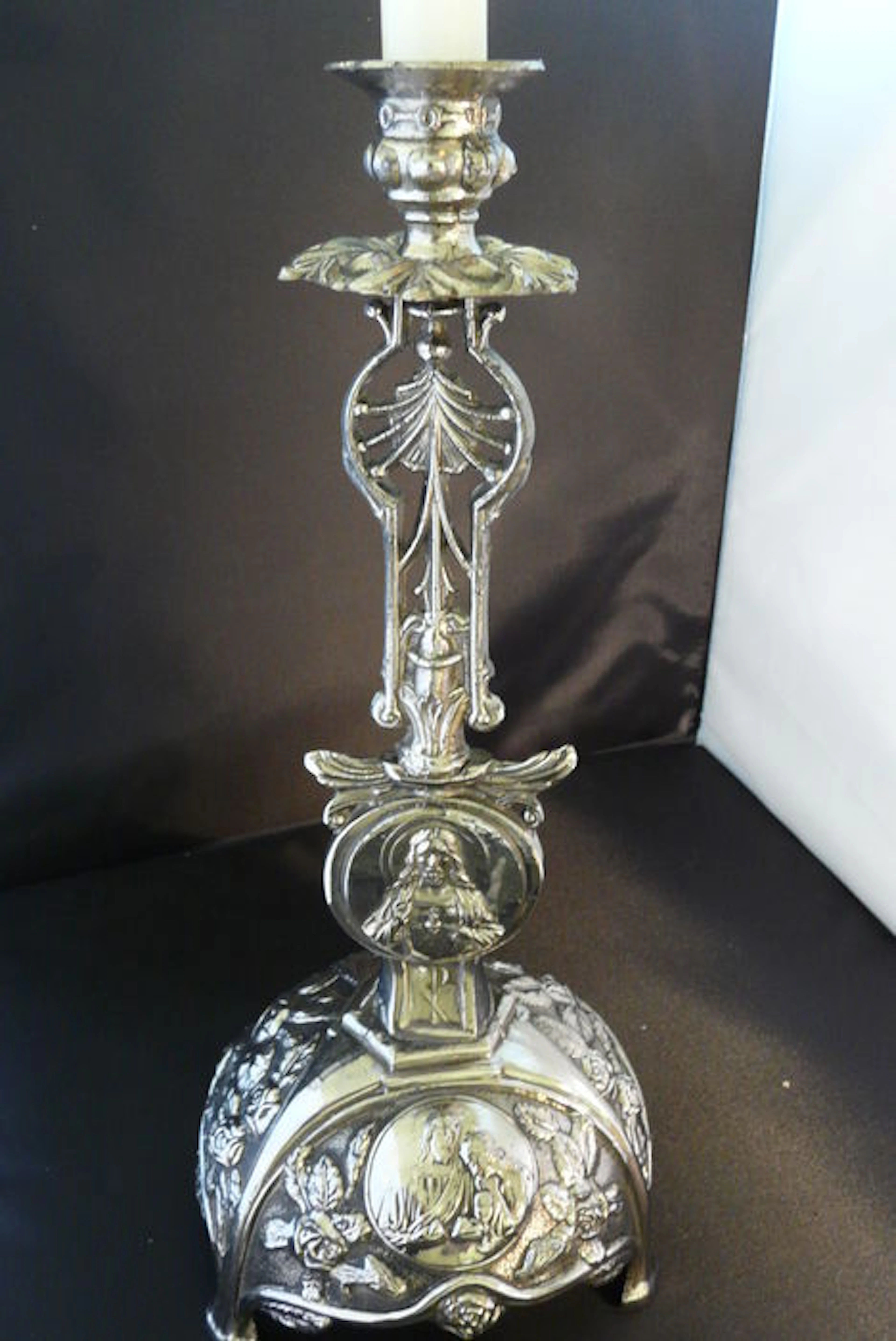 Chromed church candle holder with holy scenes and flowers