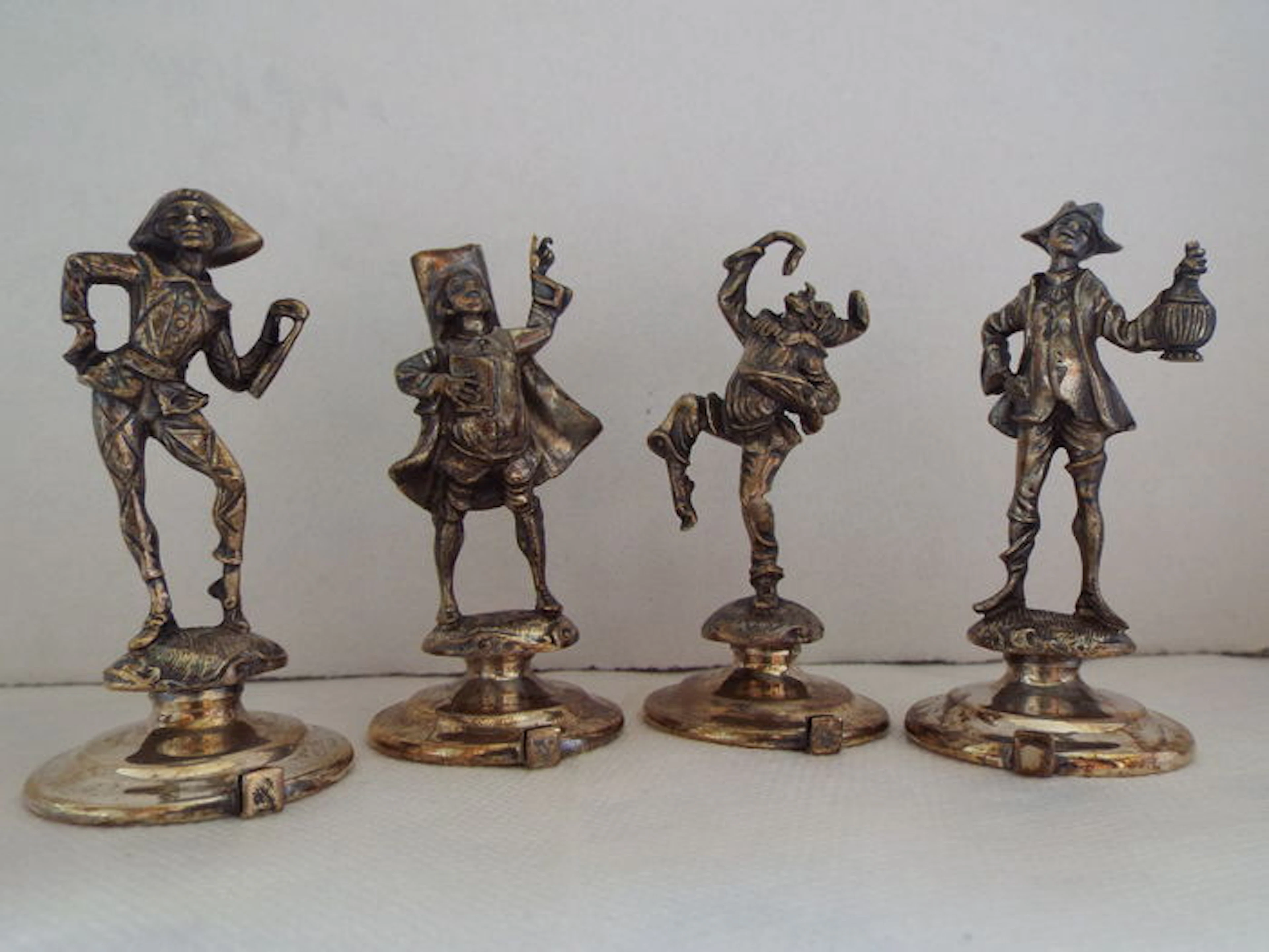 Lot of four statues in silver, Harlequin, Gianduia, Balanzone, Pulcinella