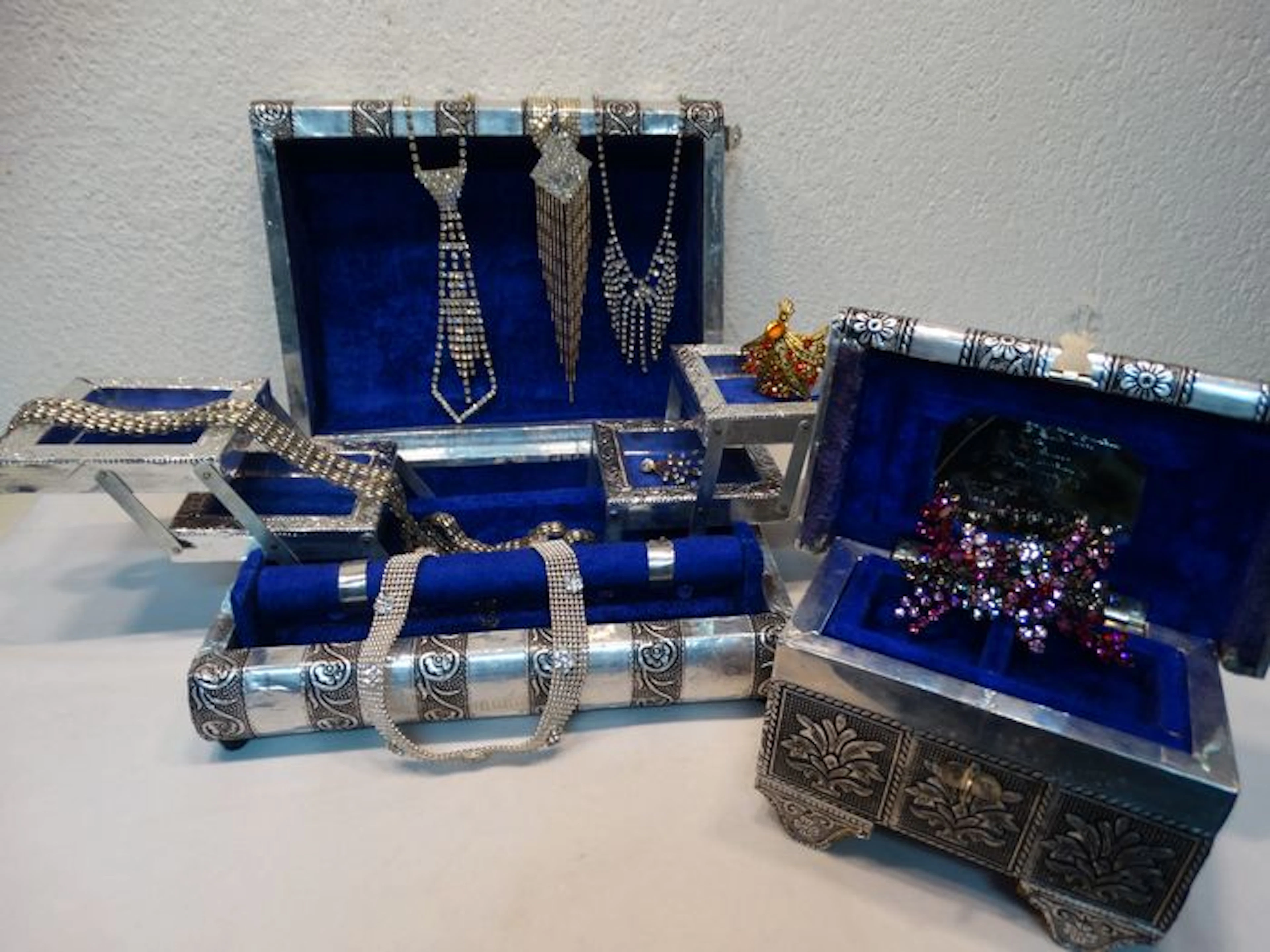 Two jewelry boxes made of wood with aluminum with various jewelry