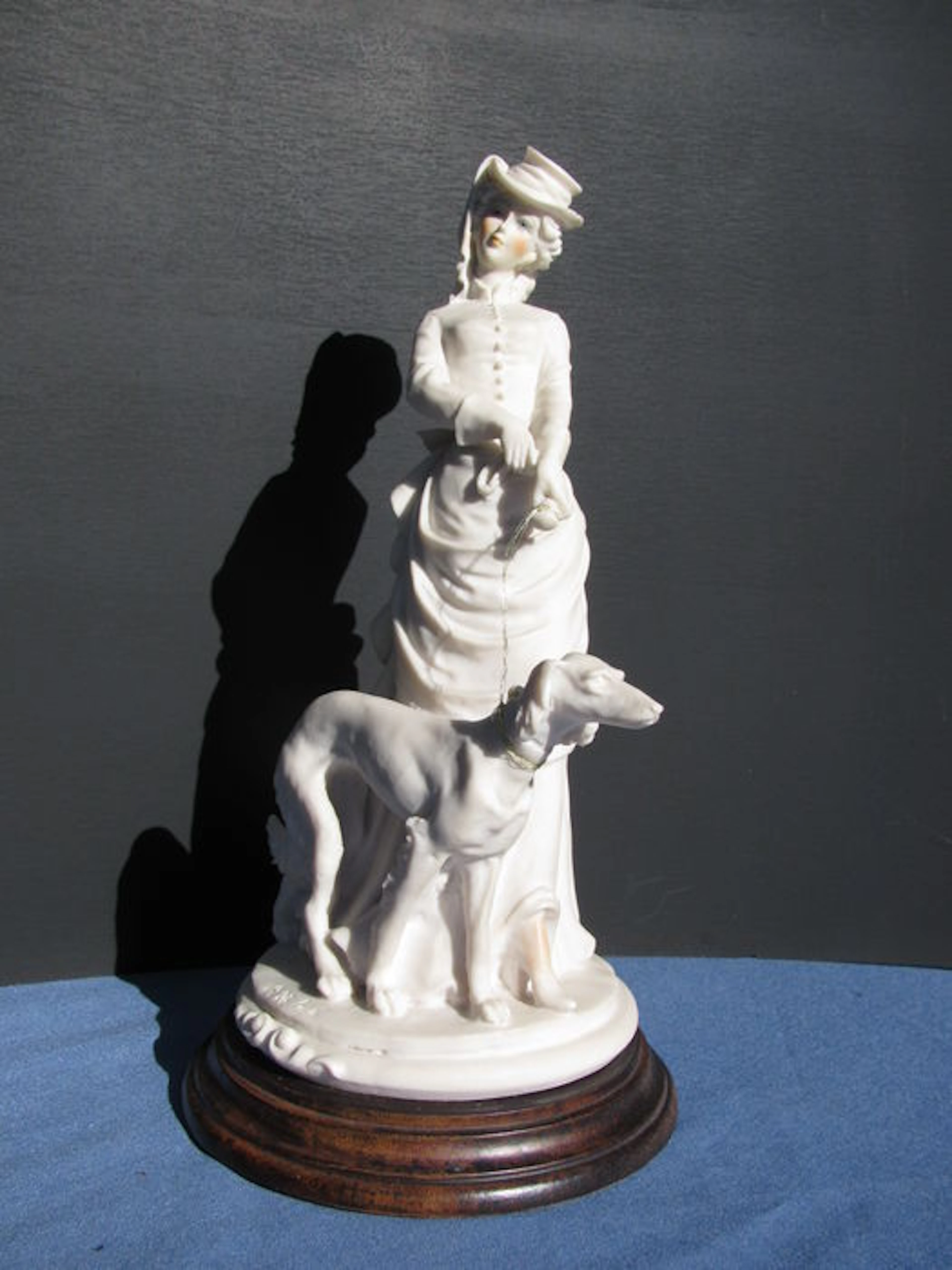 A. Belcari white porcelain statue of lady with greyhound - second half of 20th century