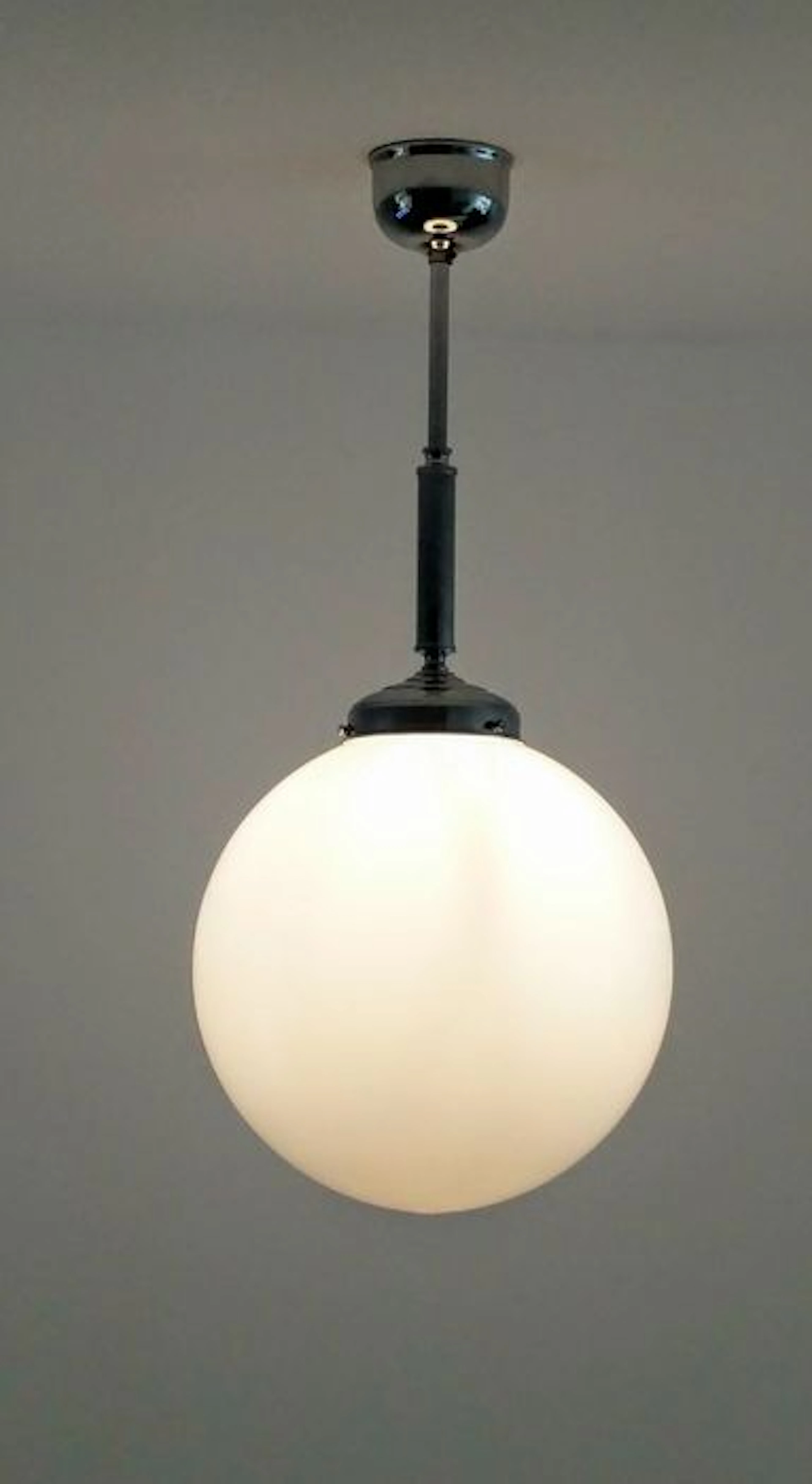 Designer unknown – Hallway light with chrome fixture and a milk glass lamp shade.
