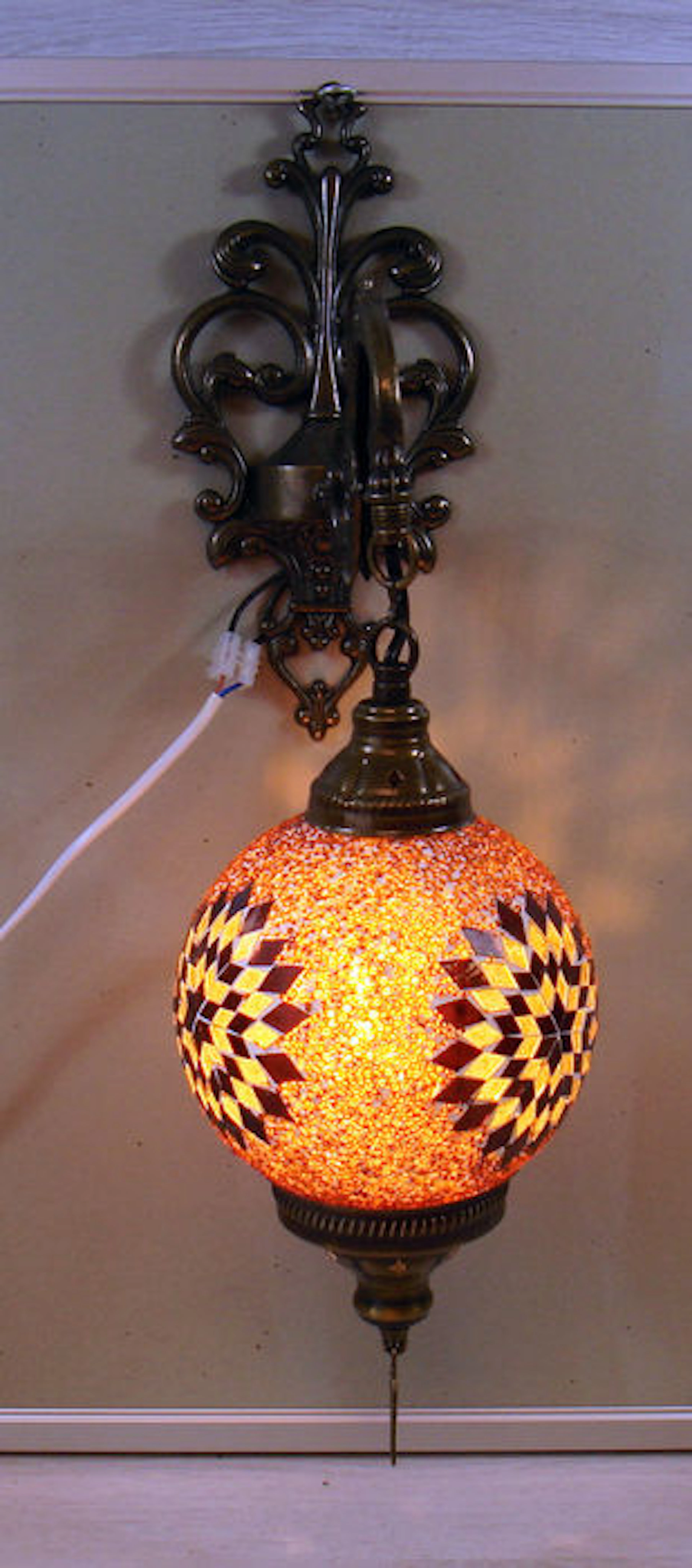 A set of two hand-inlaid glass mosaic wall-lamps with brass wall mounts
