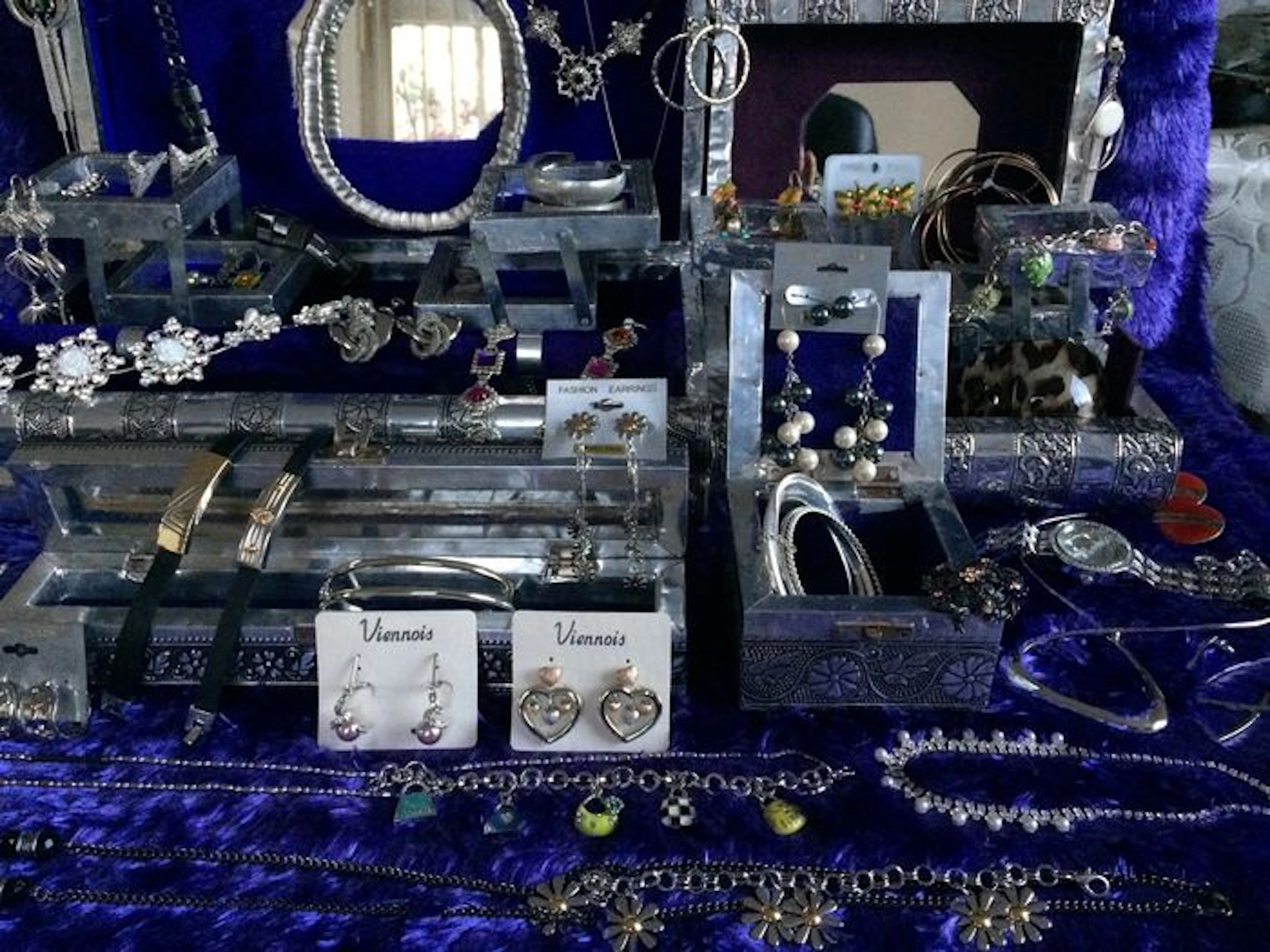4 jewelry boxes filled with 65 pieces silver-colored jewelry and 3 Candles candle holders.