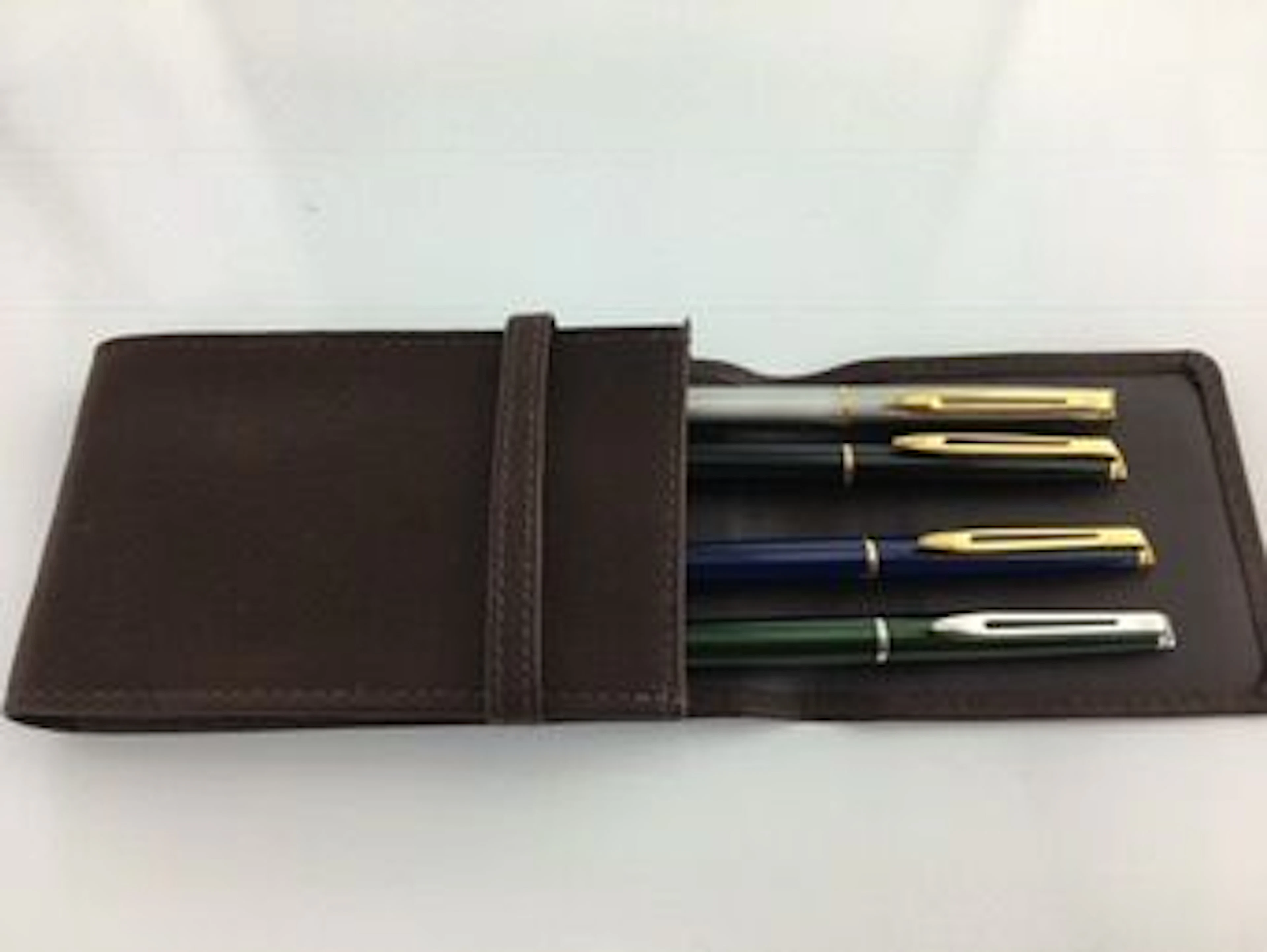4 Waterman Hemisphere pencils with 4 piece leather pen pouch. In Mint Condition.