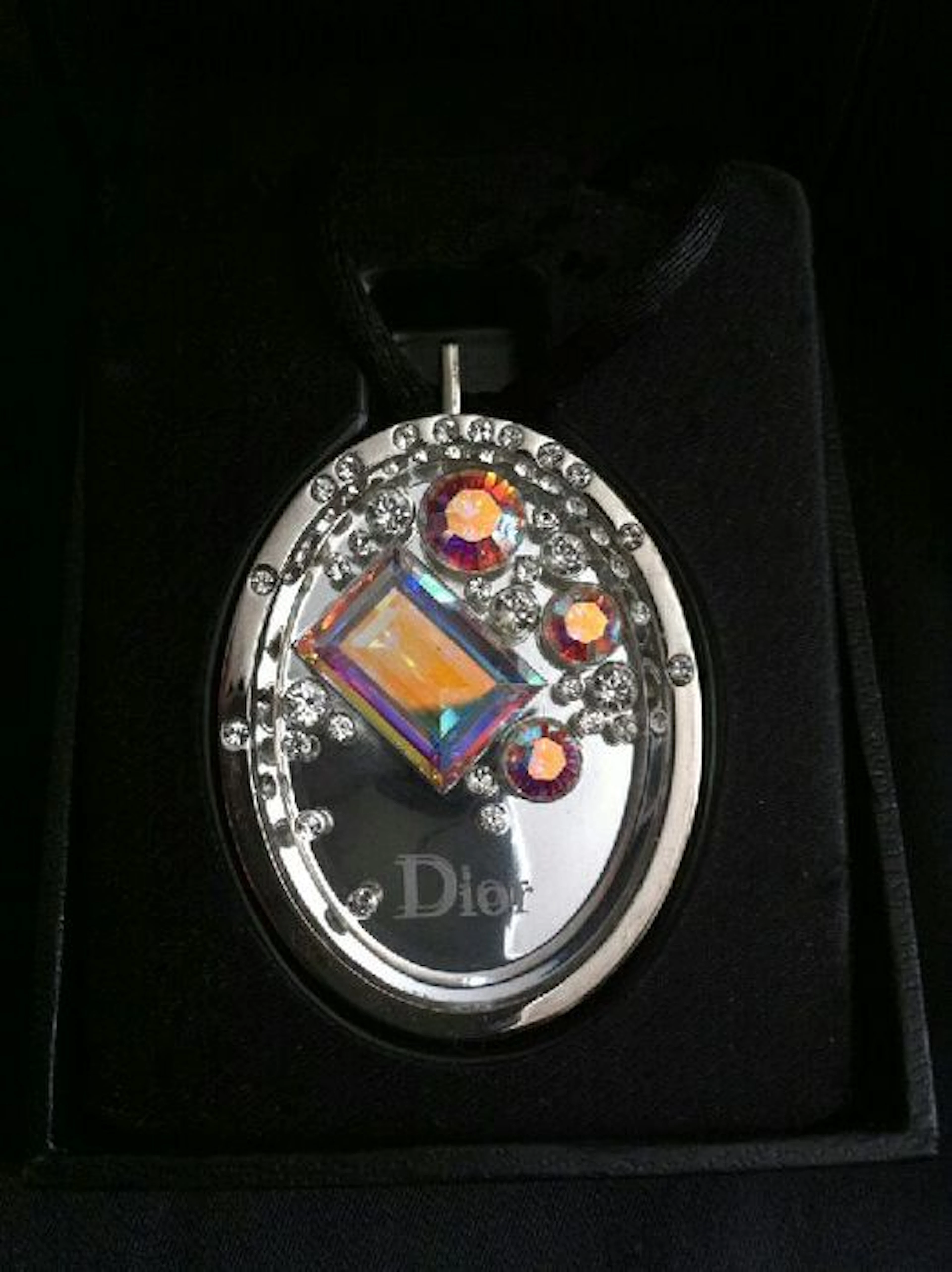 Silver metal Christian Dior pendant with crystals.