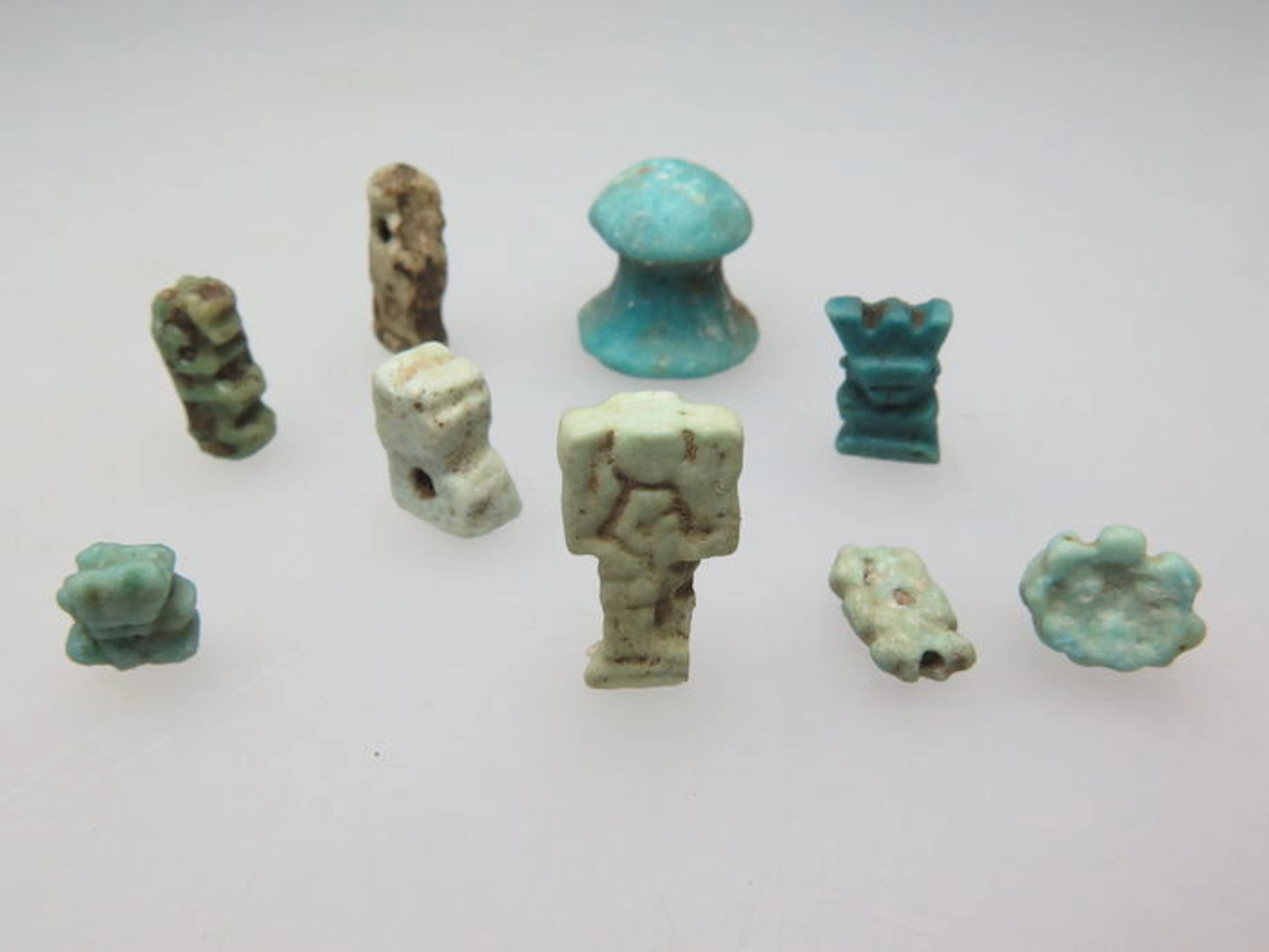 Lot of Egyptian fragments, game piece and beads including Bes and