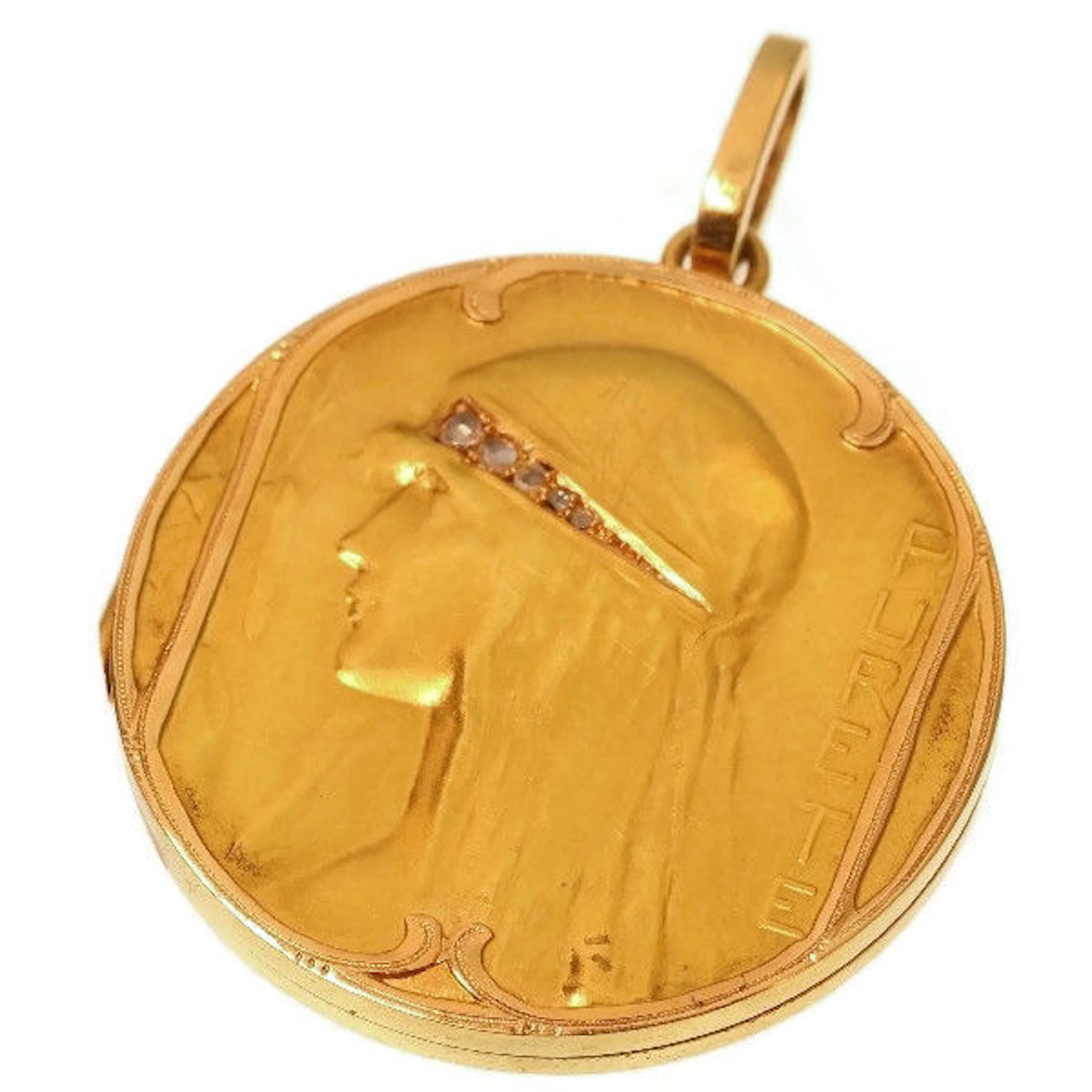 Art Nouveau gold locket pendant depicting a womans head wearing a